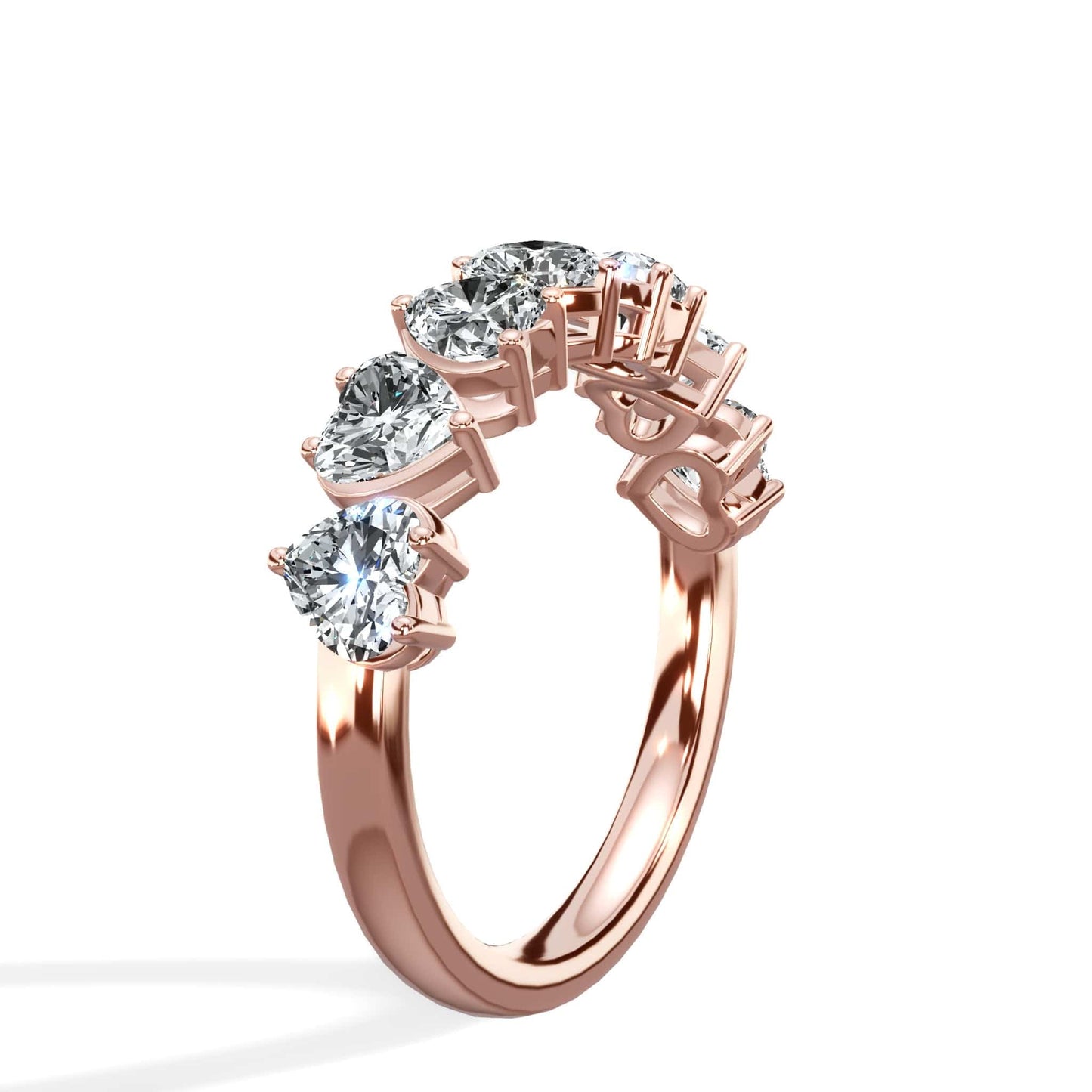 Rose gold ring with heart-shaped diamonds.