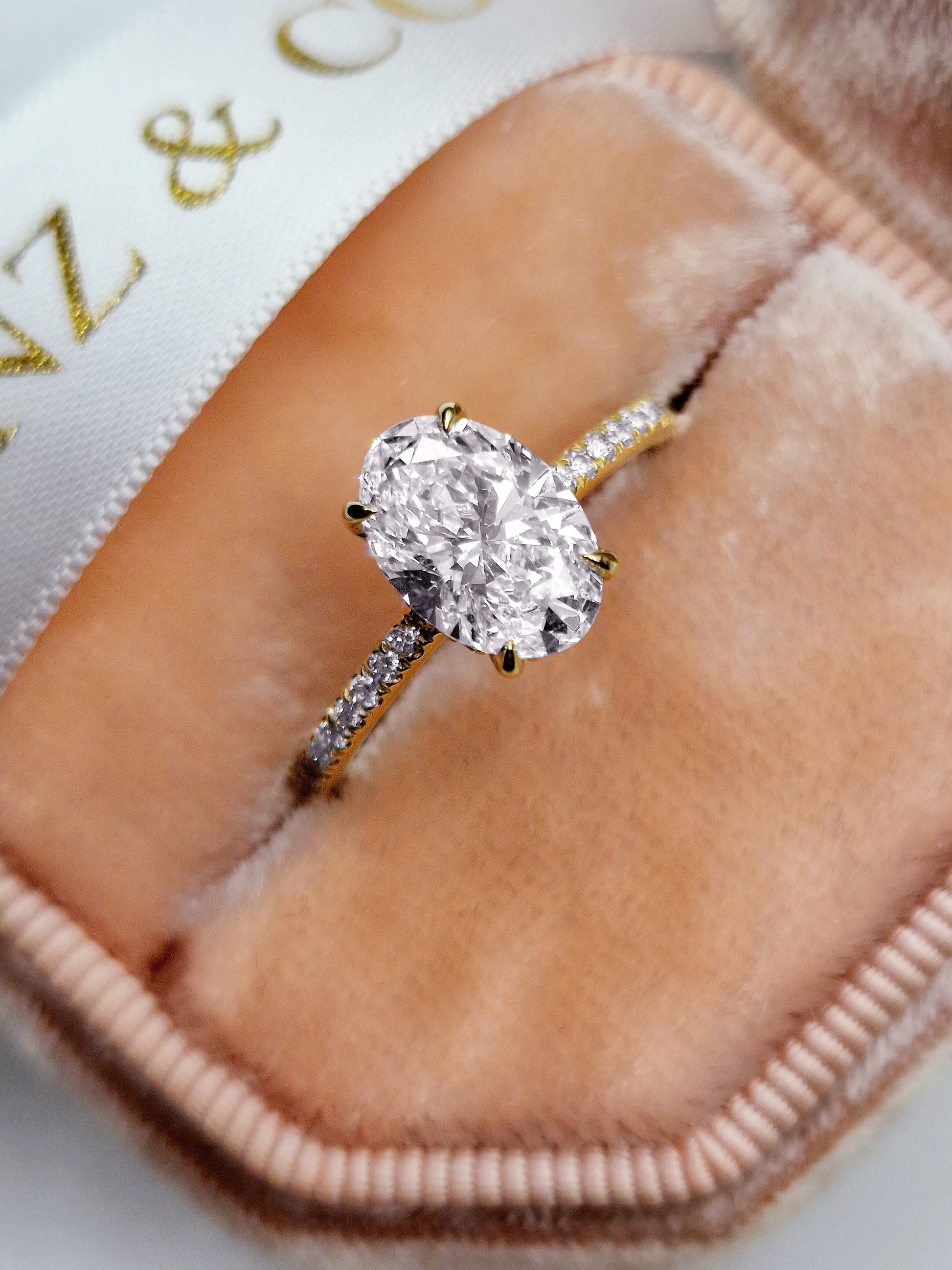 Oval diamond engagement ring in a velvet ring box.