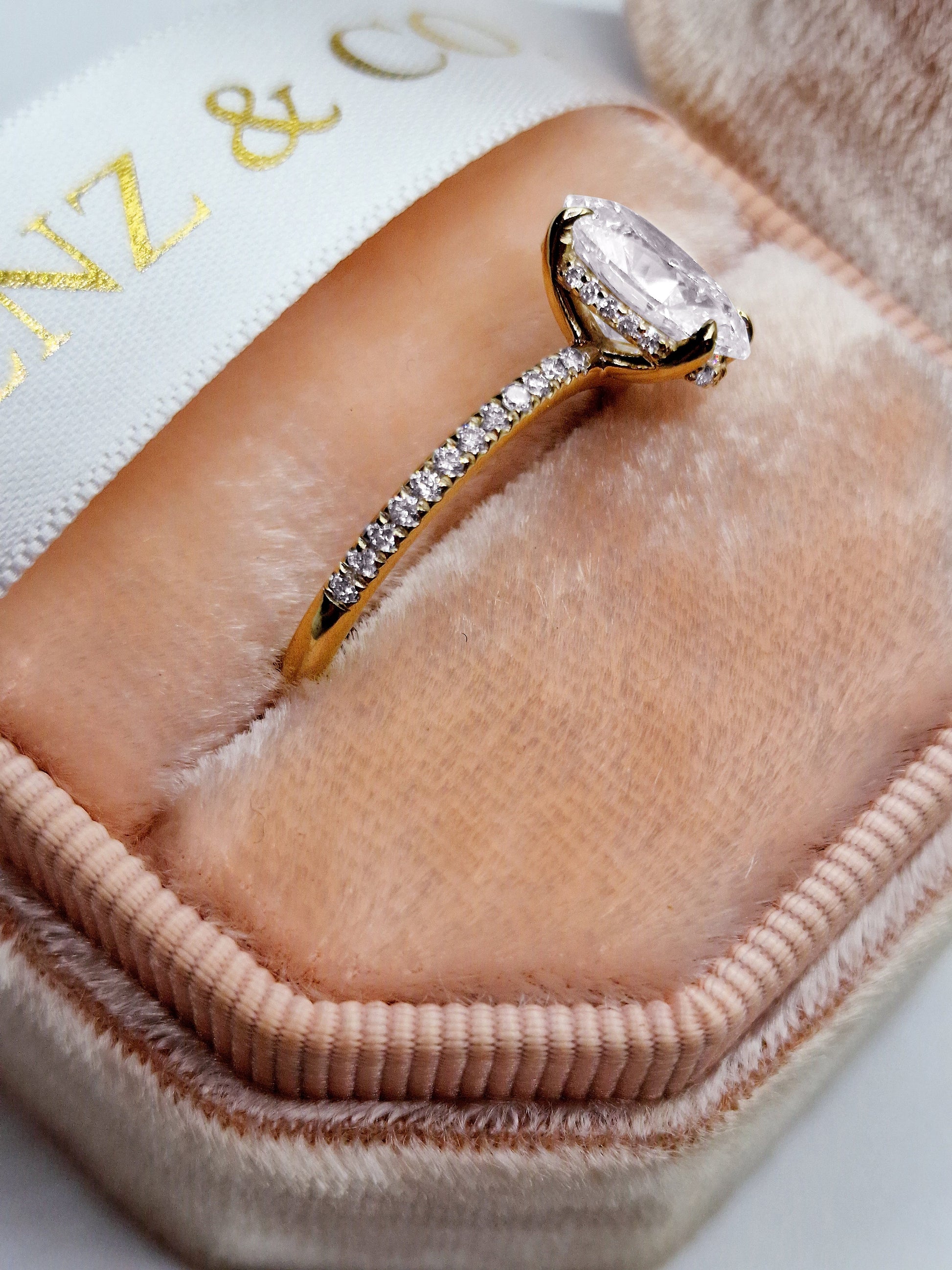 Diamond ring in a pink jewelry box.