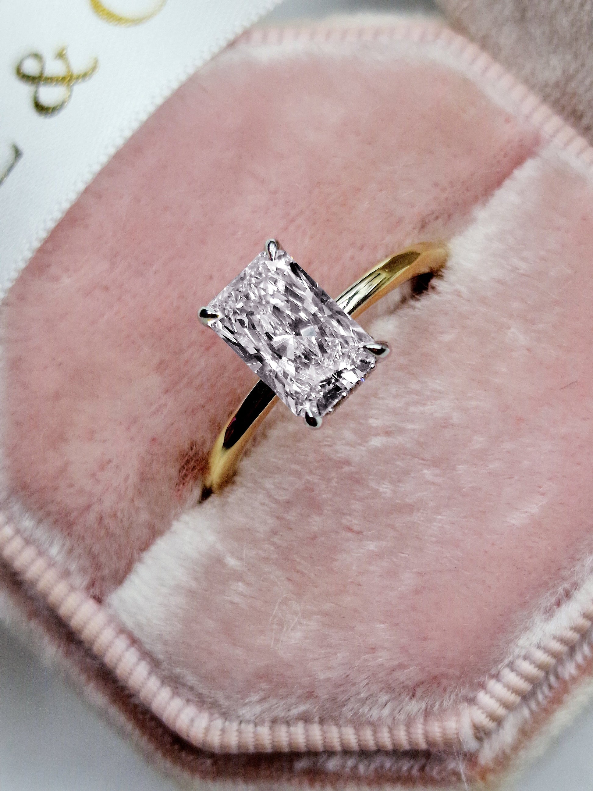 Diamond ring in a pink velvet ring box.