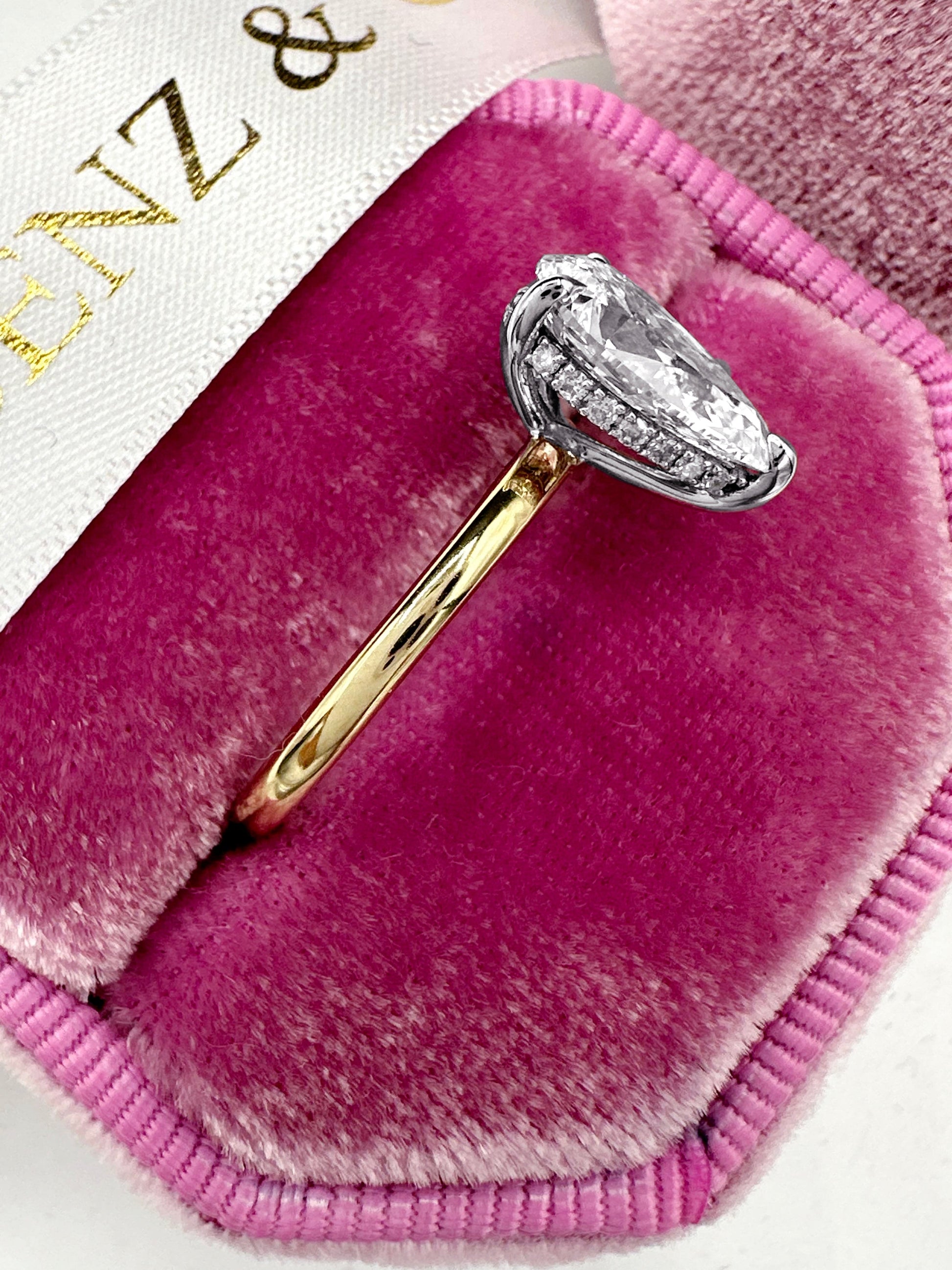 Diamond ring in a pink velvet ring box.