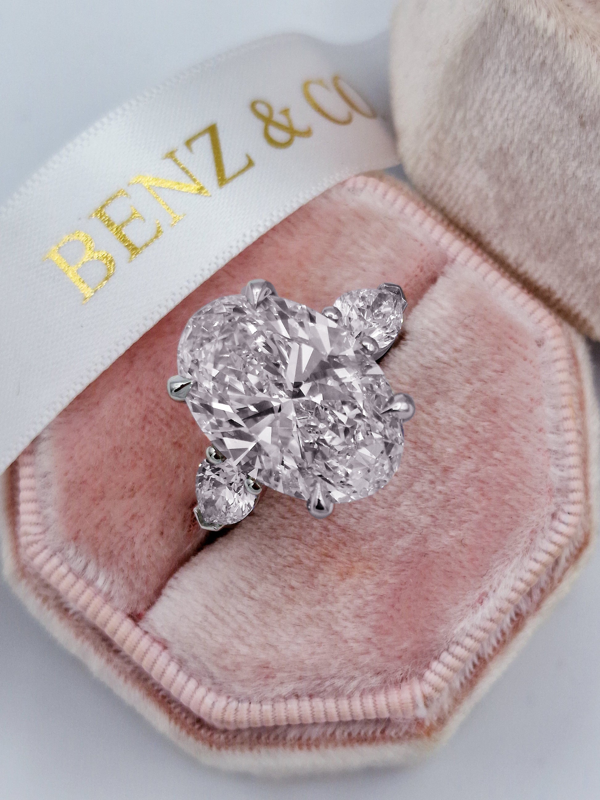 11ct oval & pear diamond three-stone engagement ring