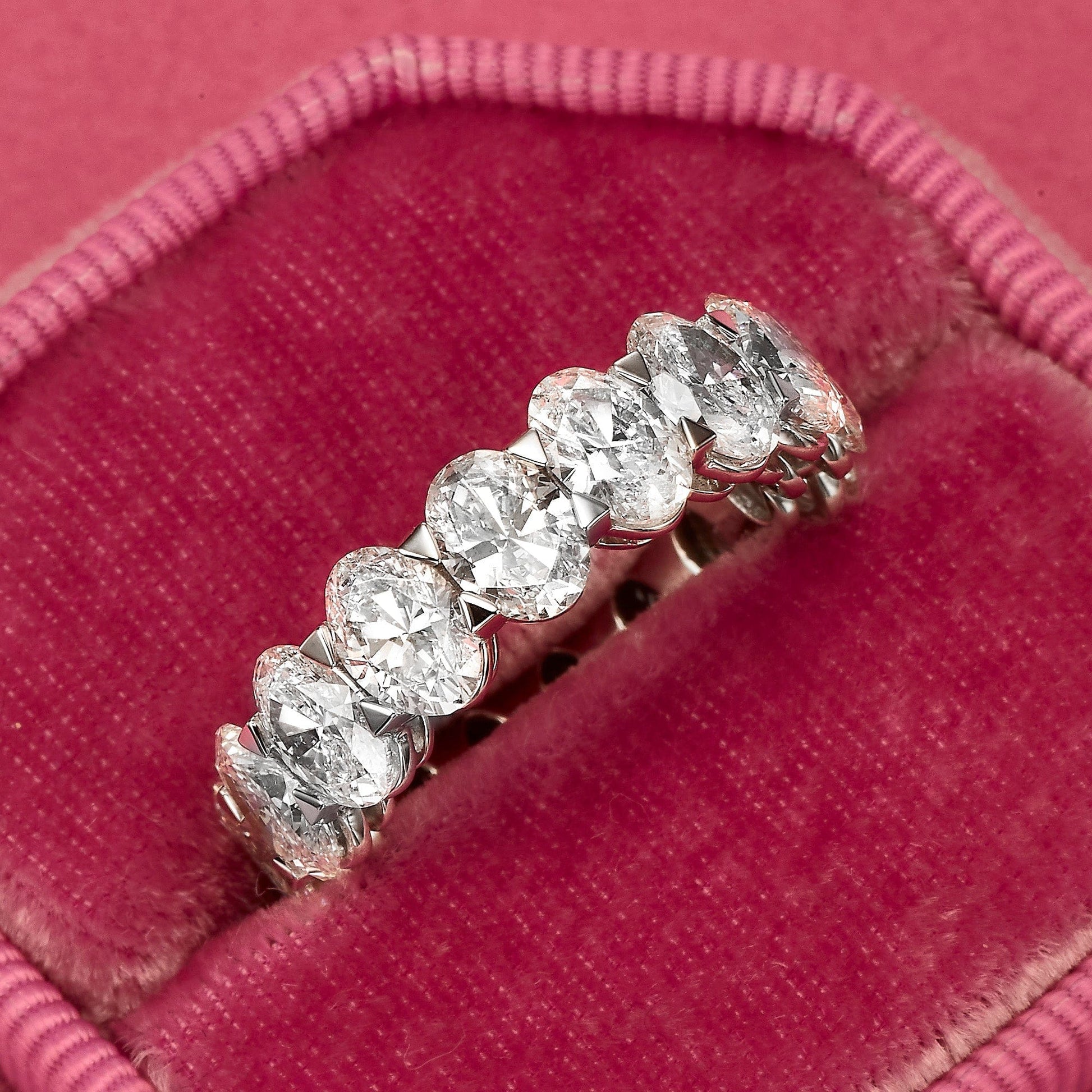 Diamond eternity ring in a pink velvet box.