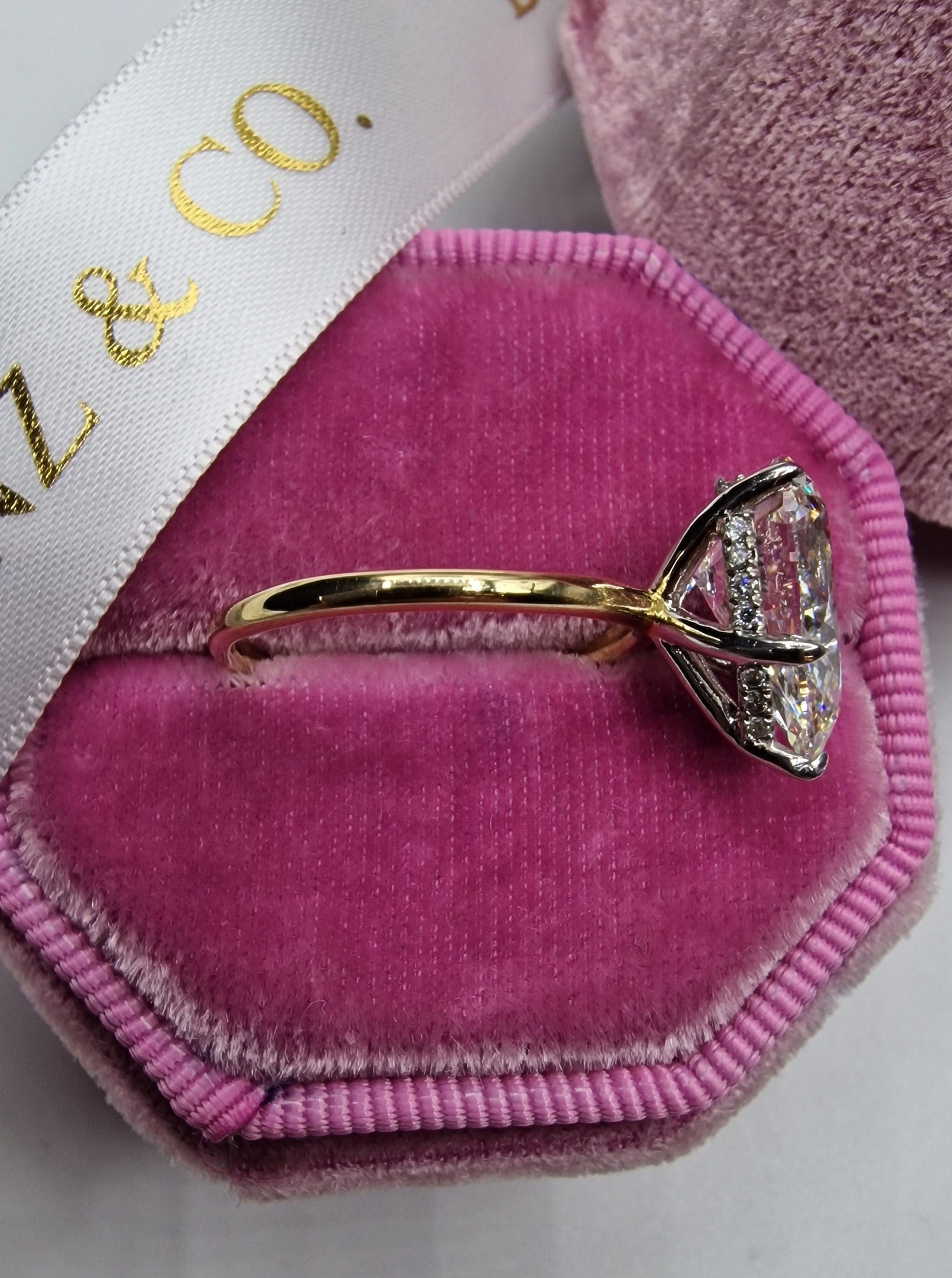 Diamond ring in pink velvet ring box.