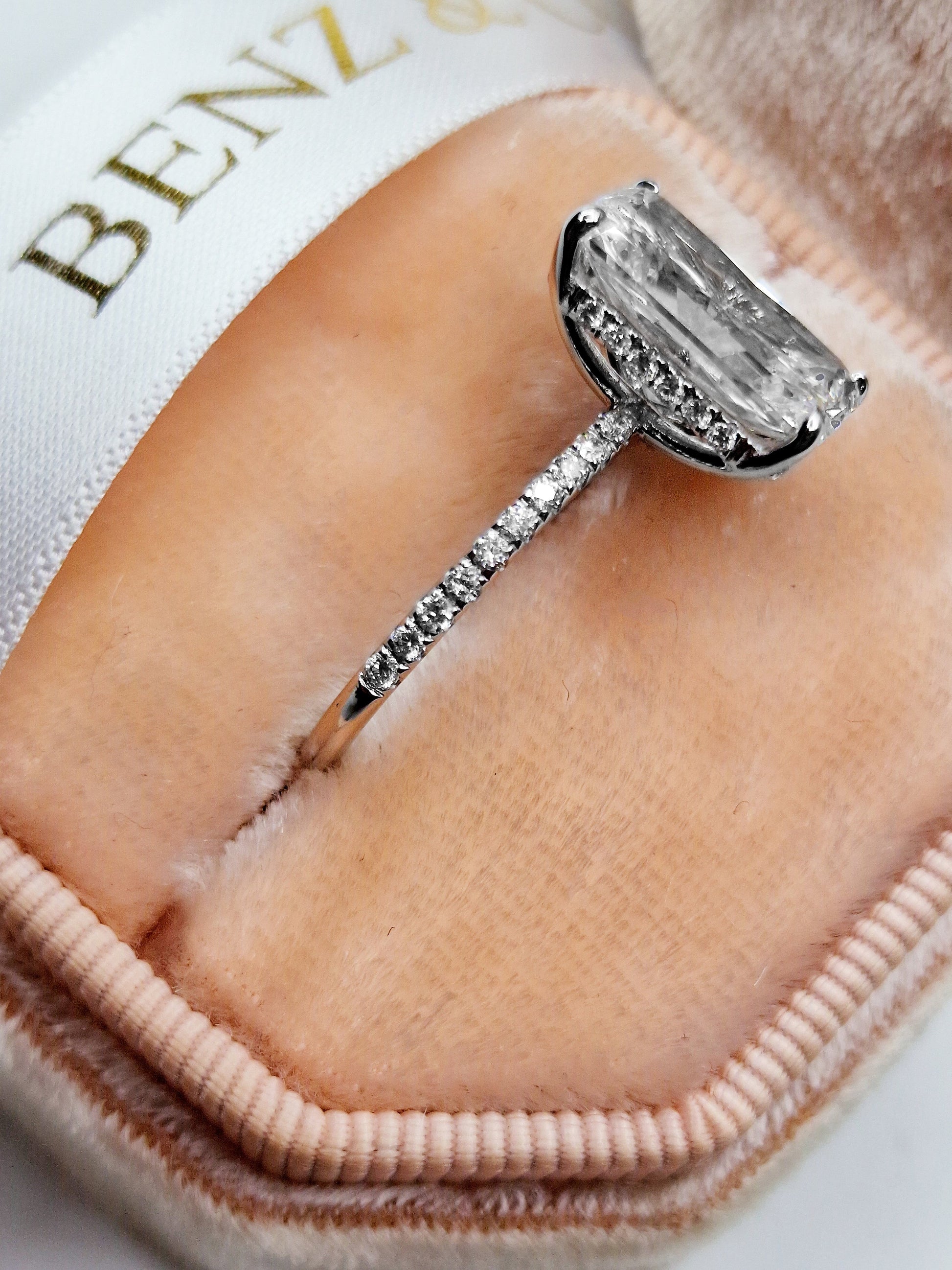 Diamond engagement ring in a pink velvet box.