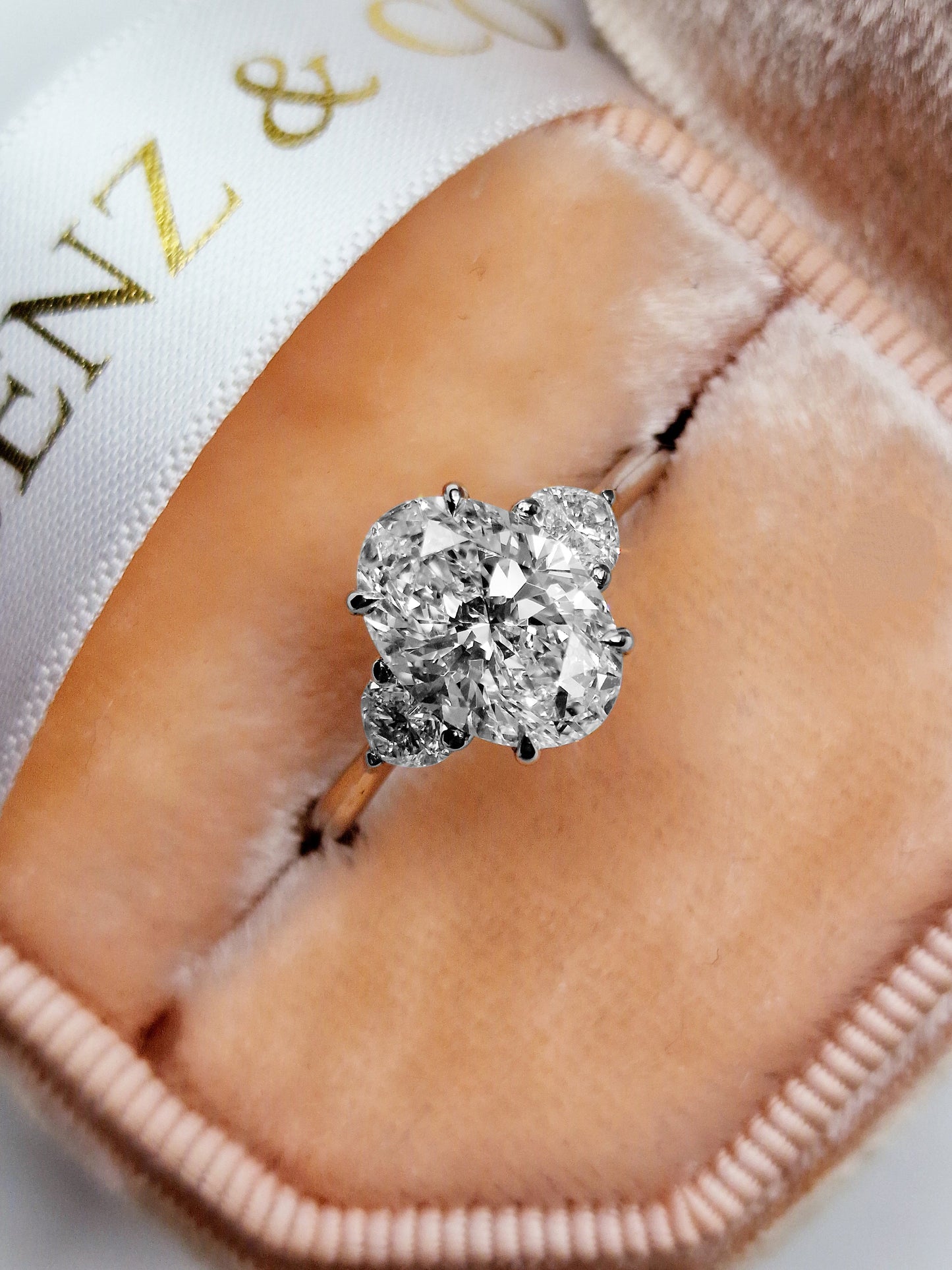 Diamond cluster ring in a pink velvet box.