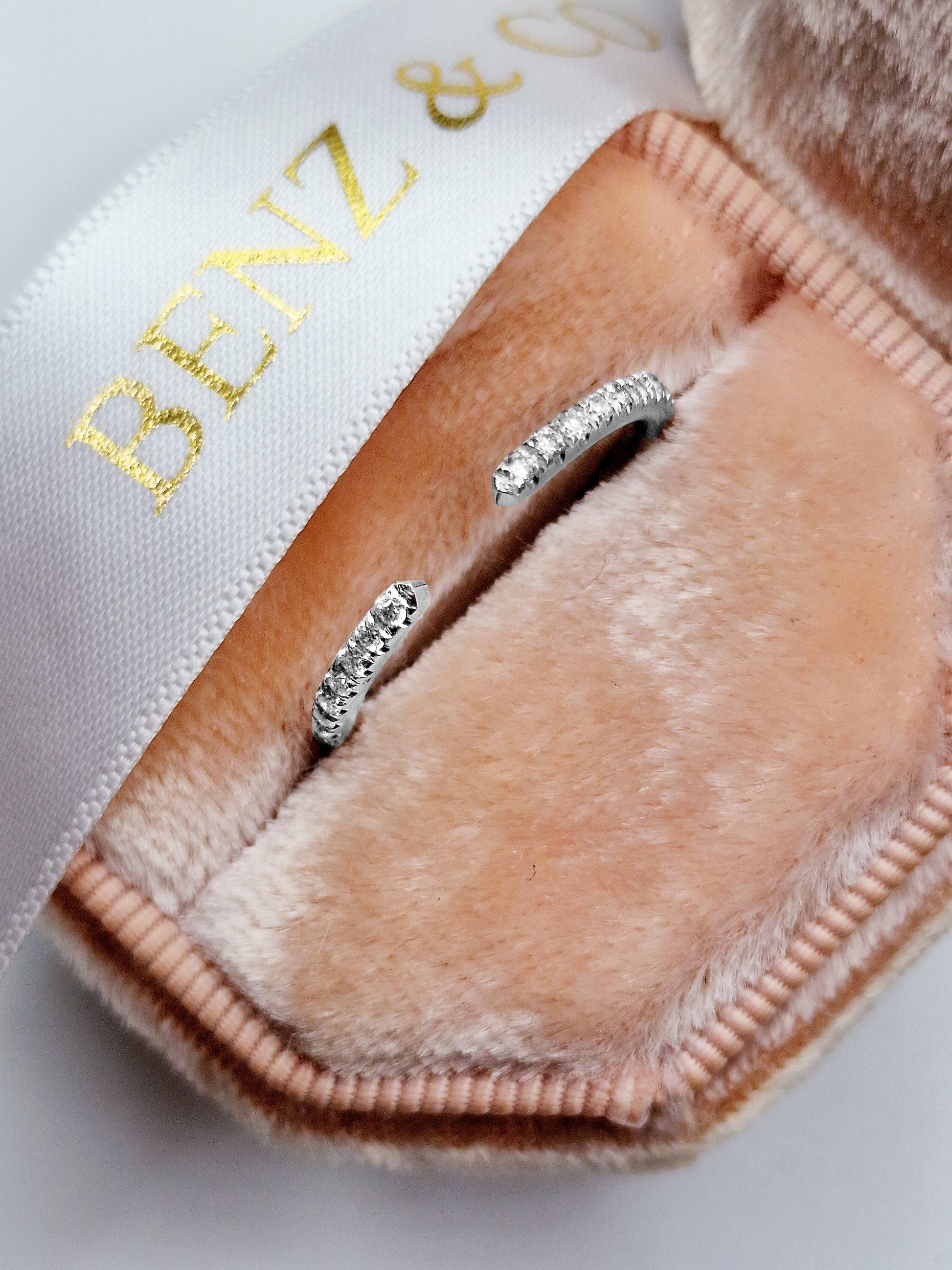 Diamond ring in a pink velvet jewelry box.