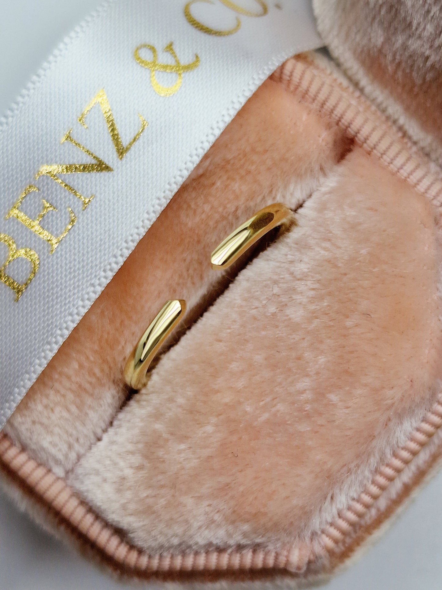 Gold ring in a pink velvet box.