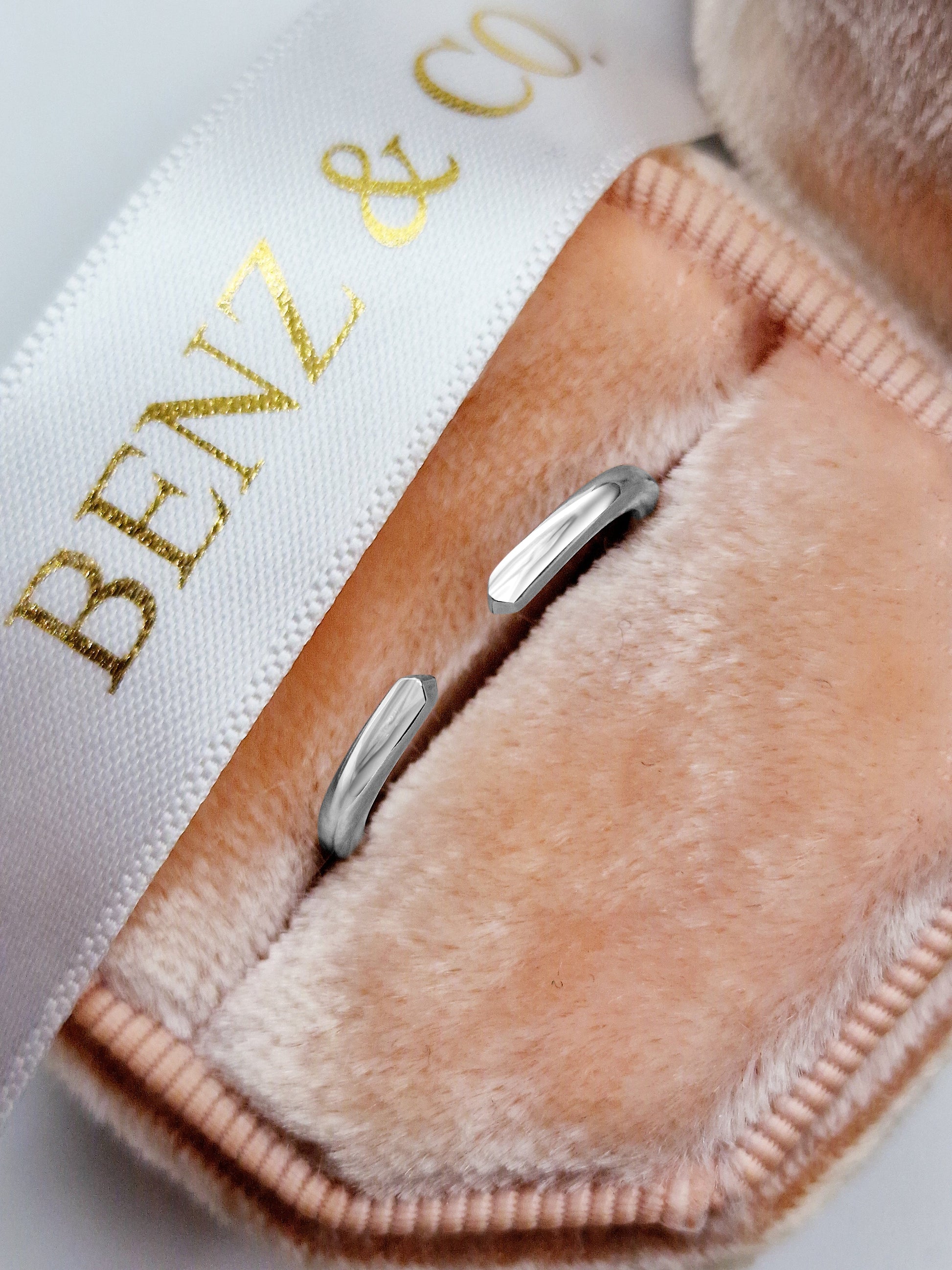 Silver ring in pink velvet box.