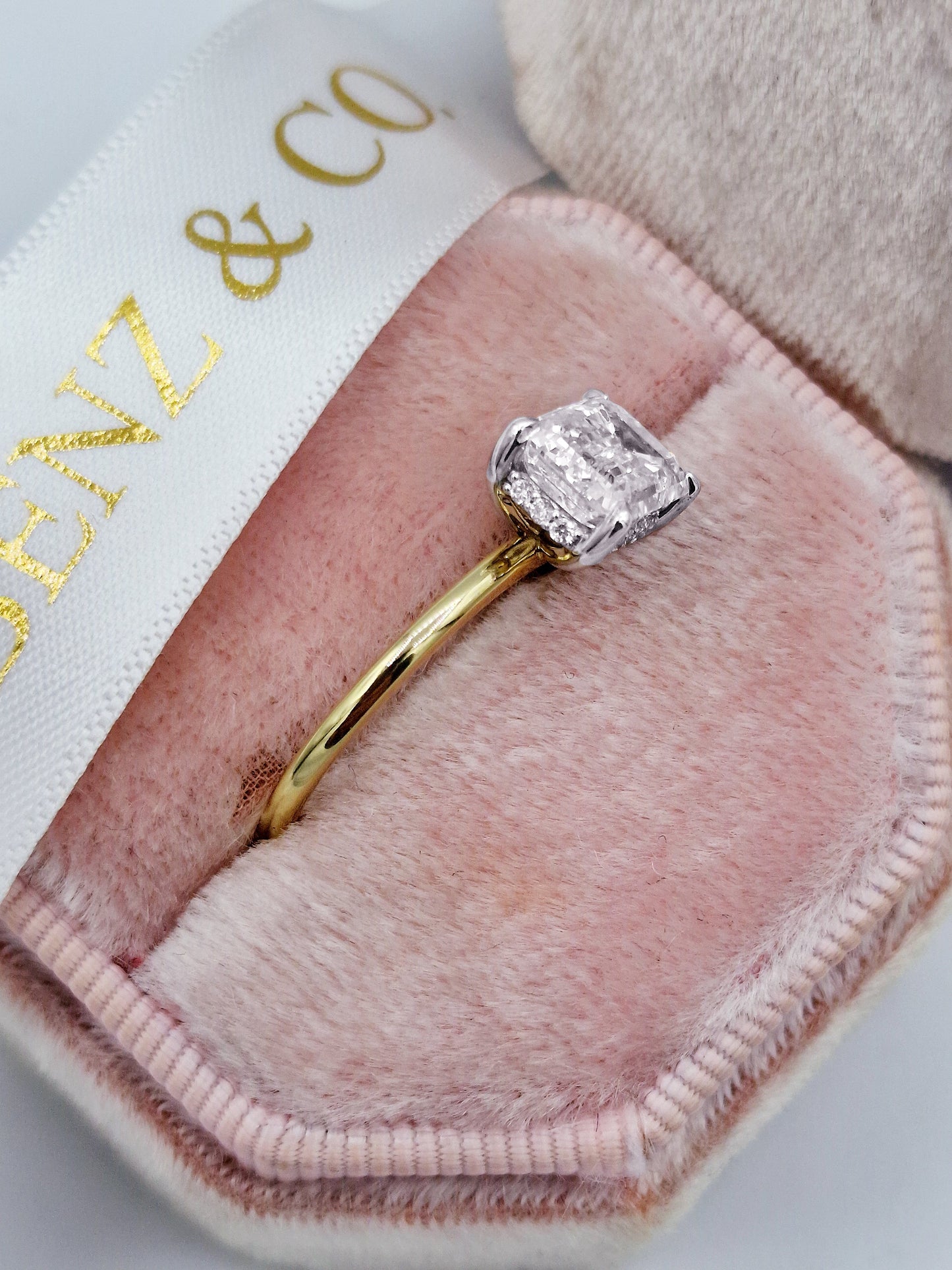 2ct Emerald cut east-west two-tone diamond engagement ring