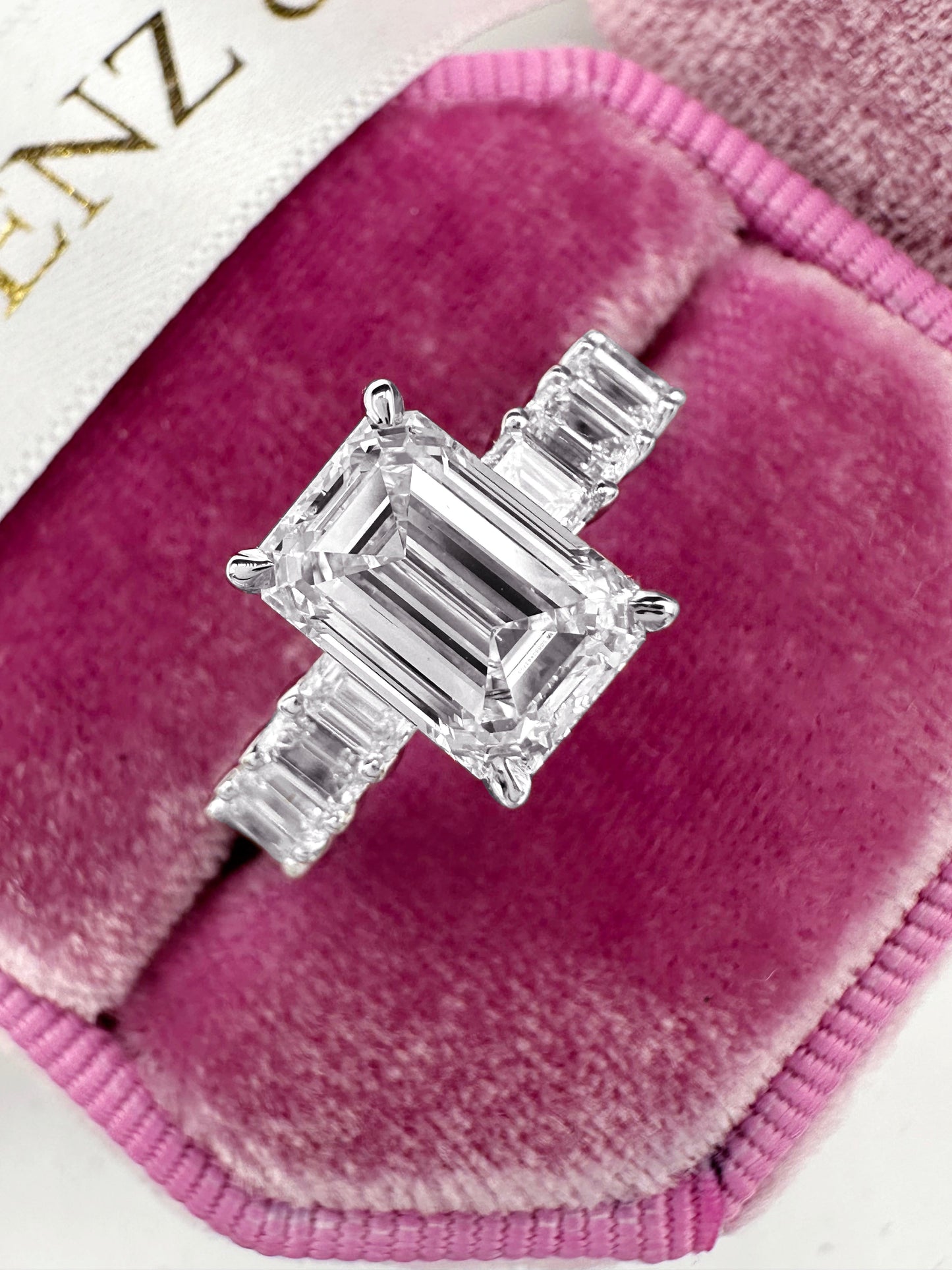 Emerald cut diamond engagement ring with side stones in white gold