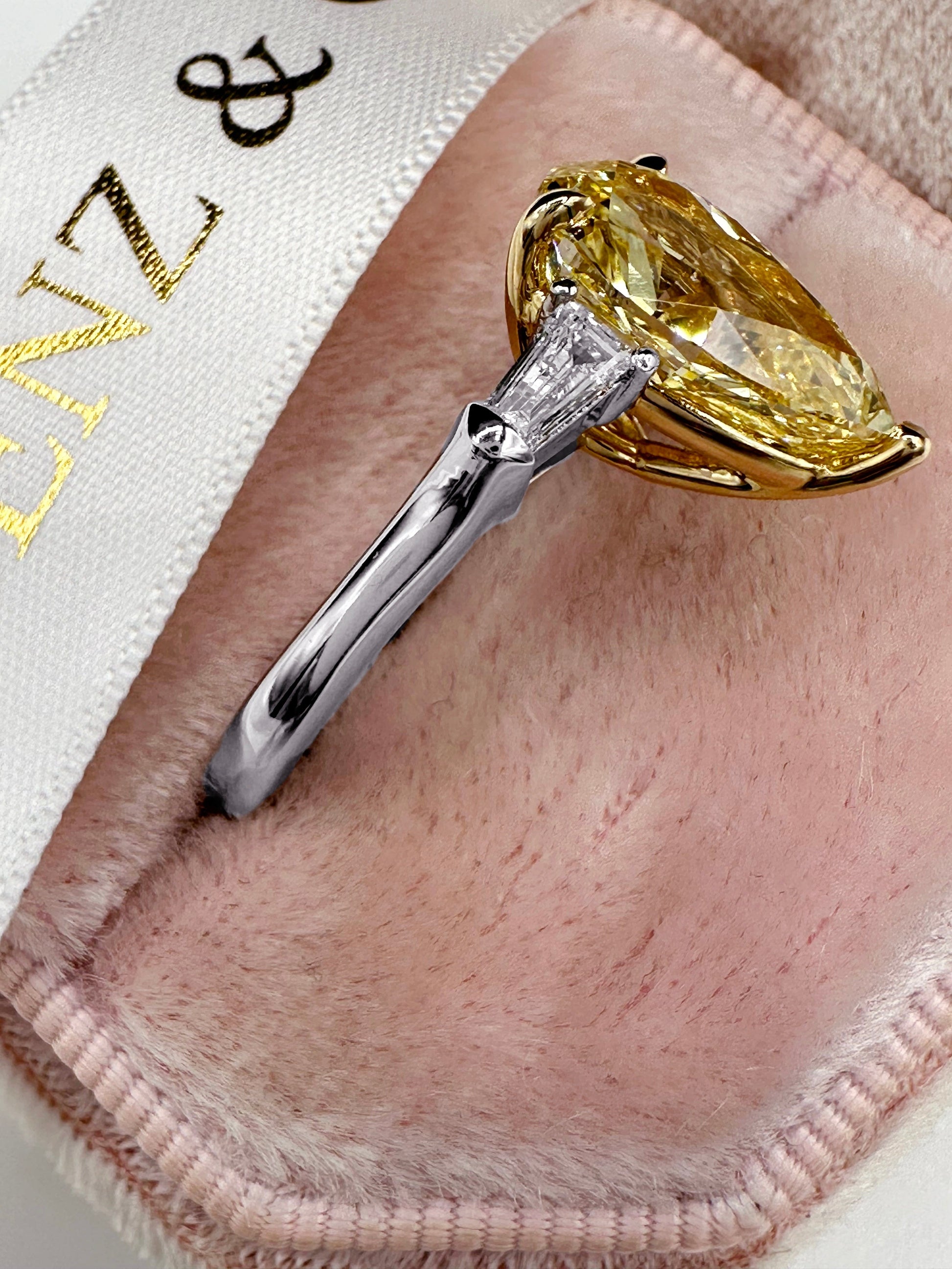 Diamond ring in a pink jewelry box.