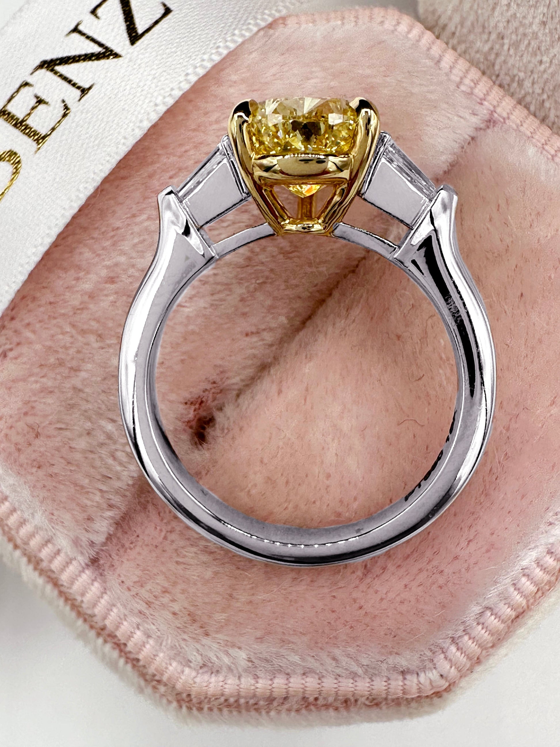 Diamond ring with yellow center stone.