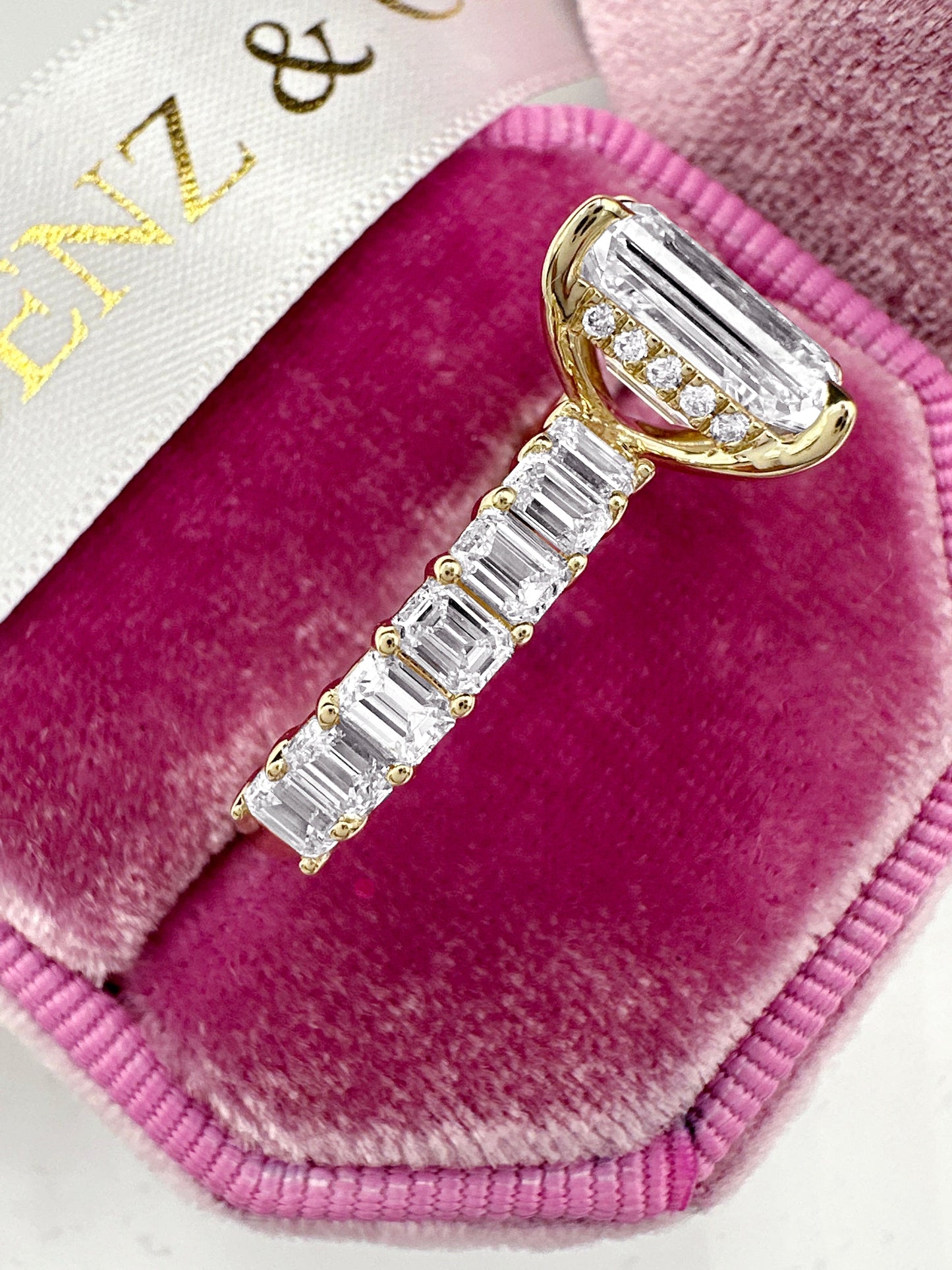 Emerald cut diamond engagement ring with hidden halo, yellow gold