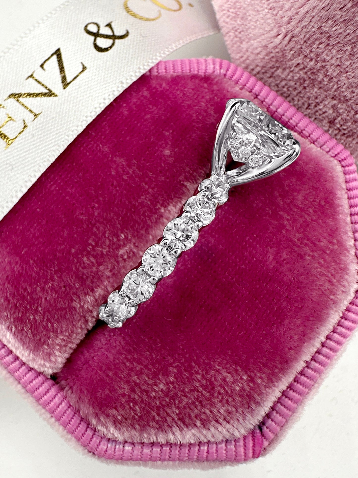 Cushion cut diamond ring with eternity band and hidden halo.