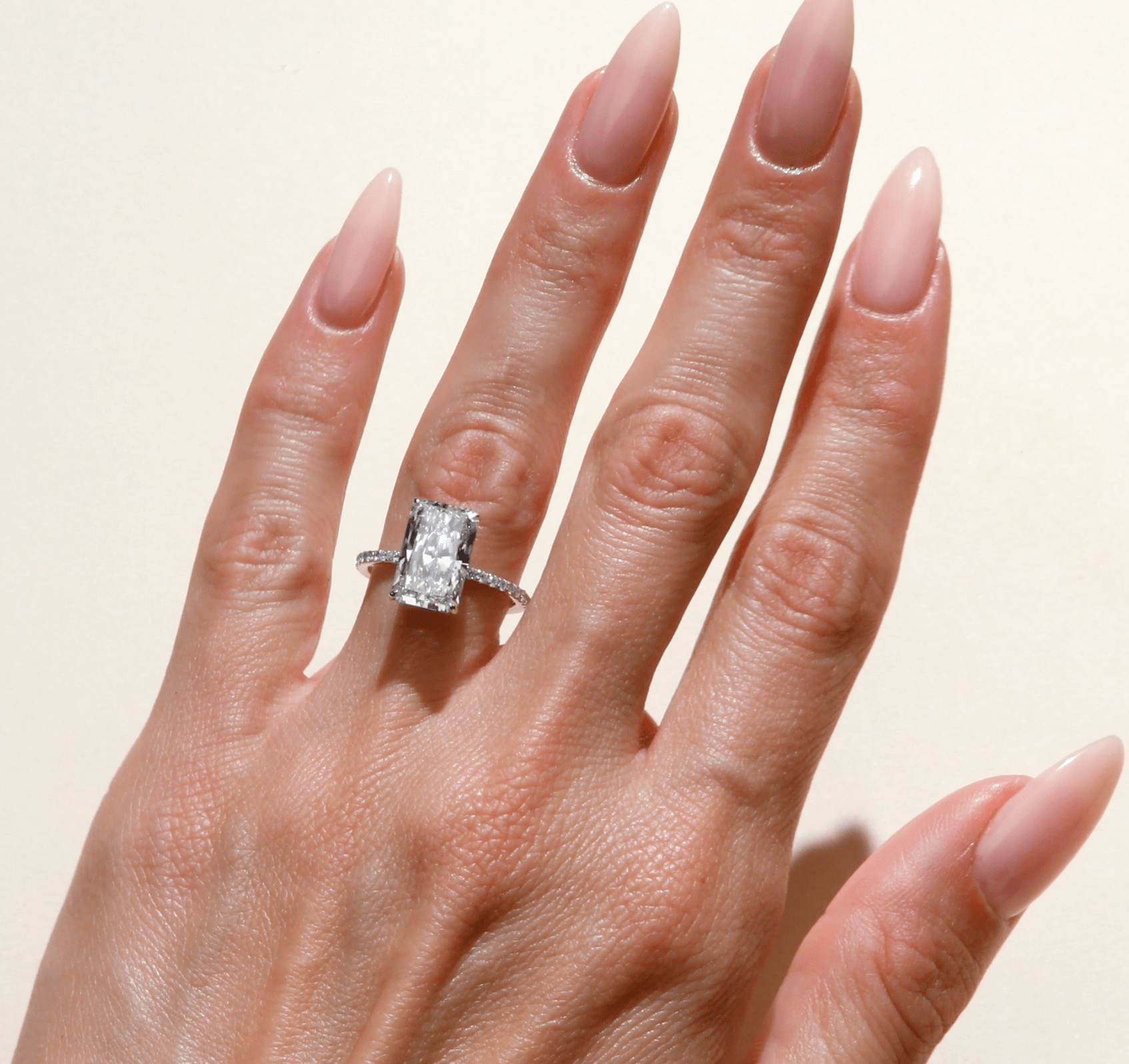 Elongated radiant cut engagement ring on hand