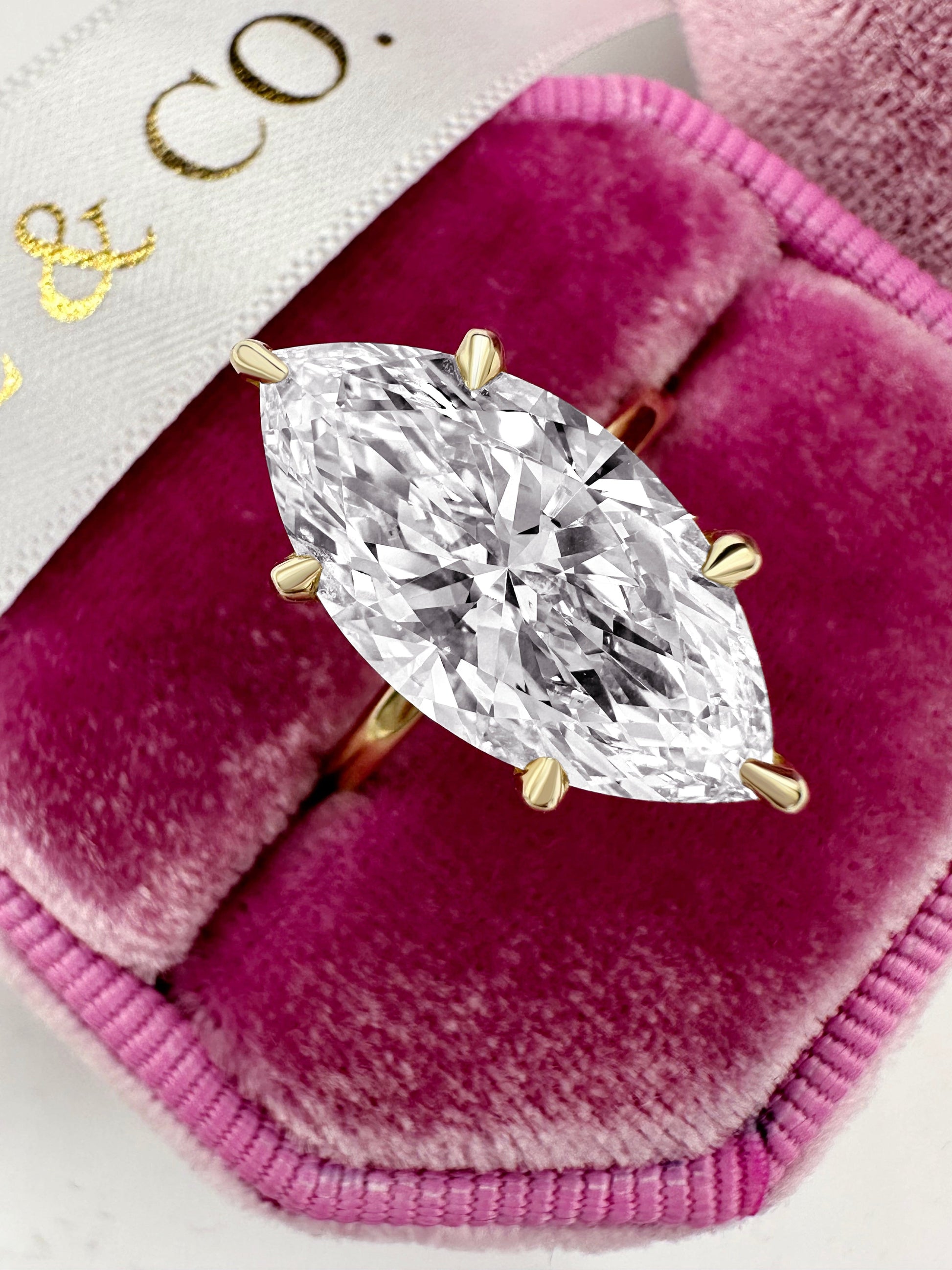 5ct marquise diamond hidden halo engagement ring in yellow gold