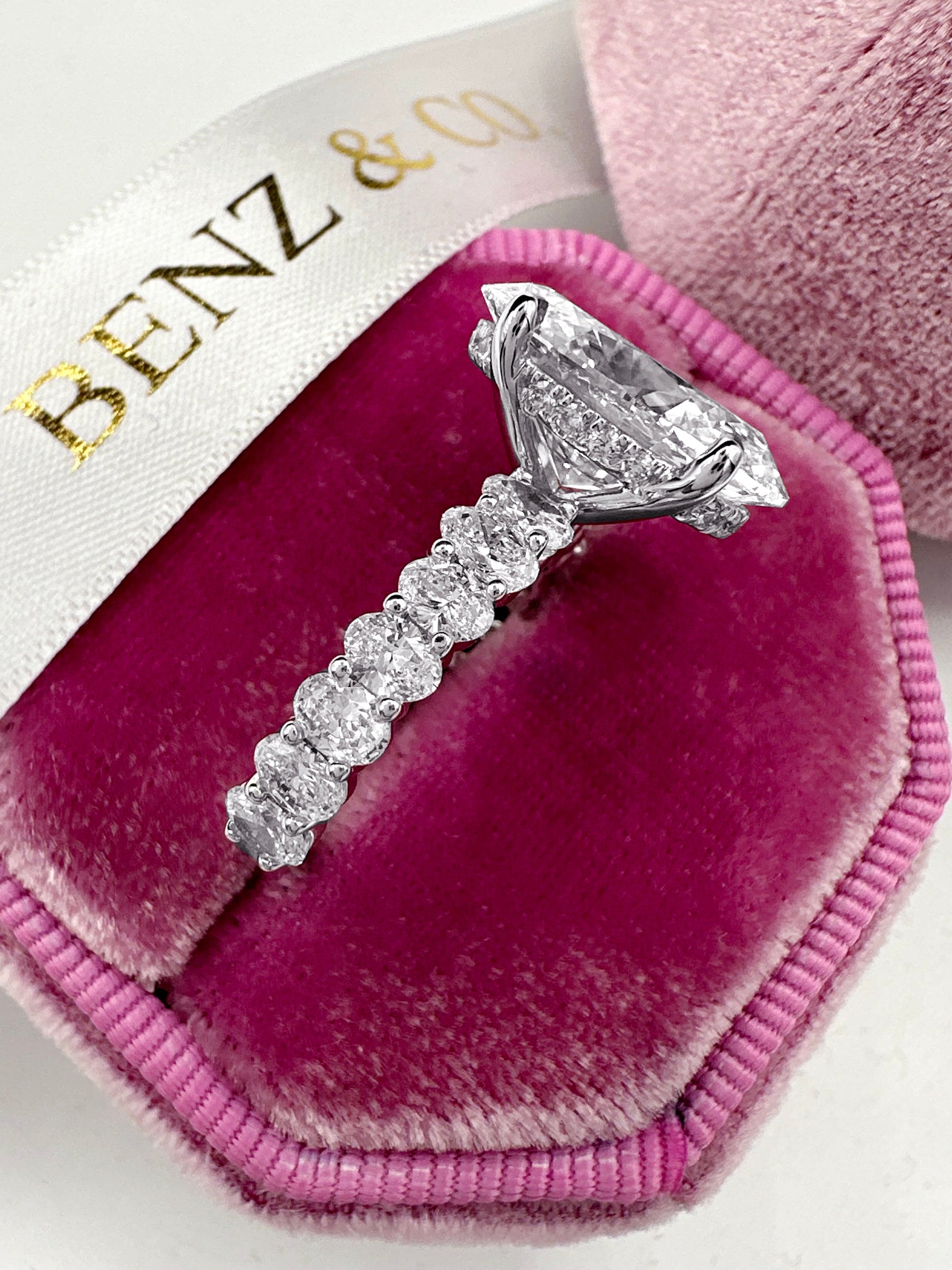 Oval cut diamond ring with half eternity band