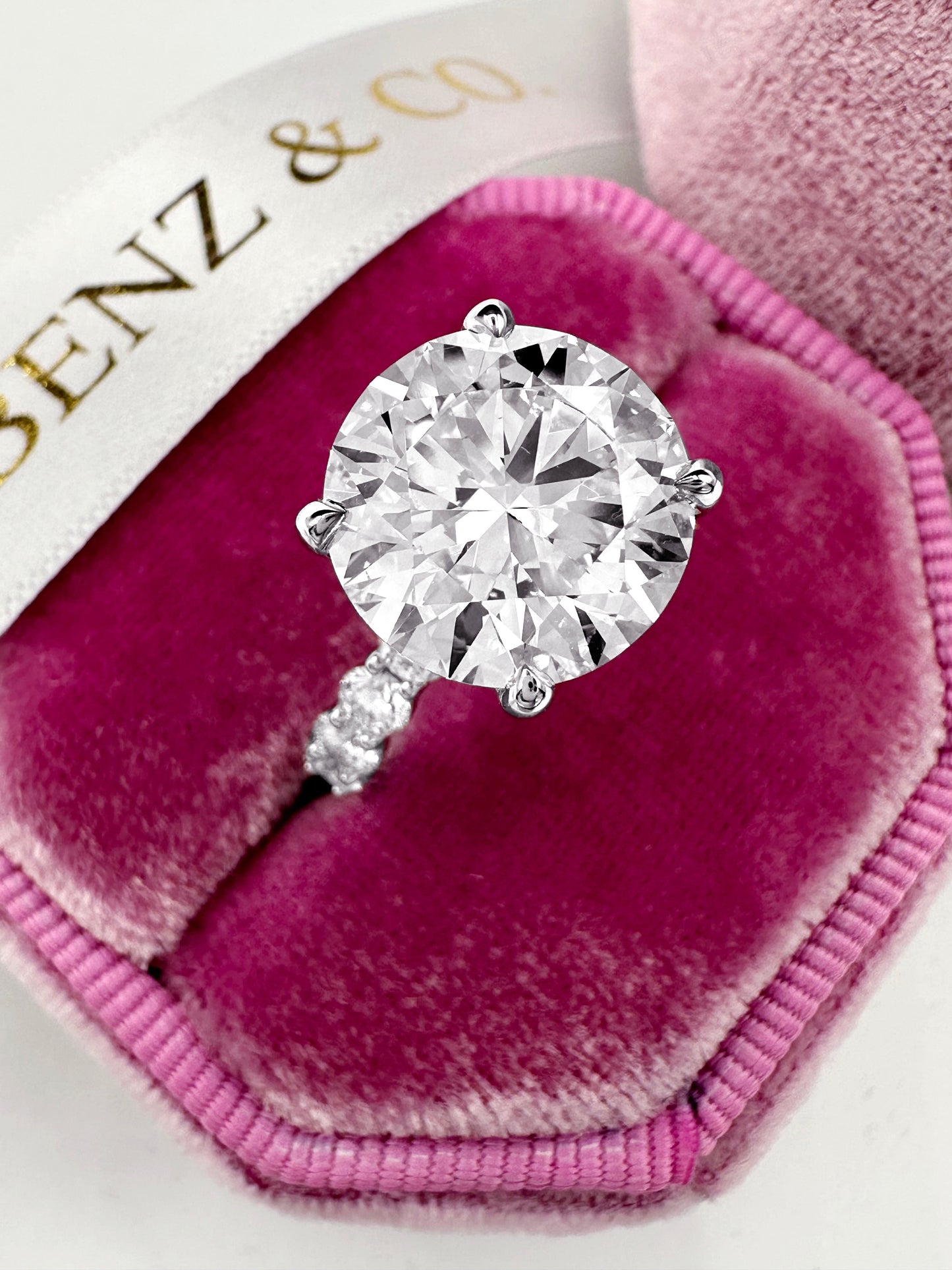 5ct lab grown diamond ring with side diamonds and hidden halo in white gold.