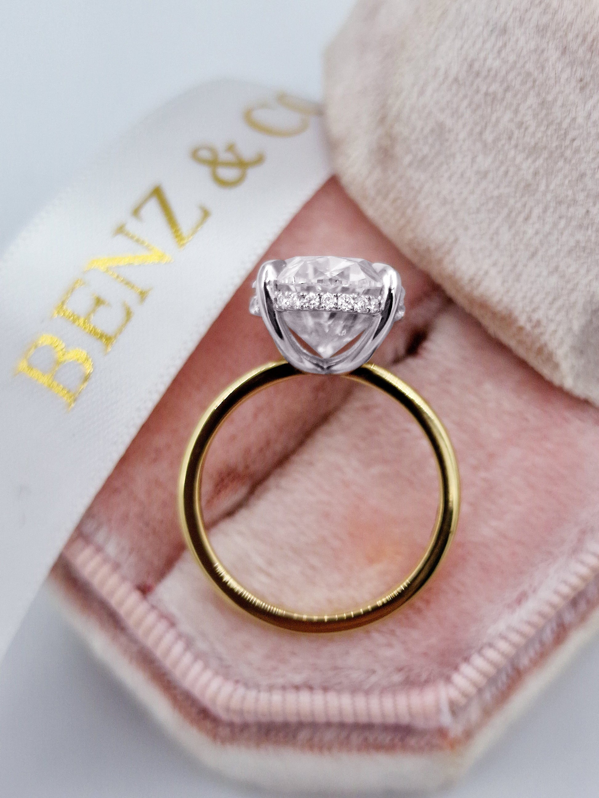 7ct oval diamond two-tone ring with hidden halo, yellow gold