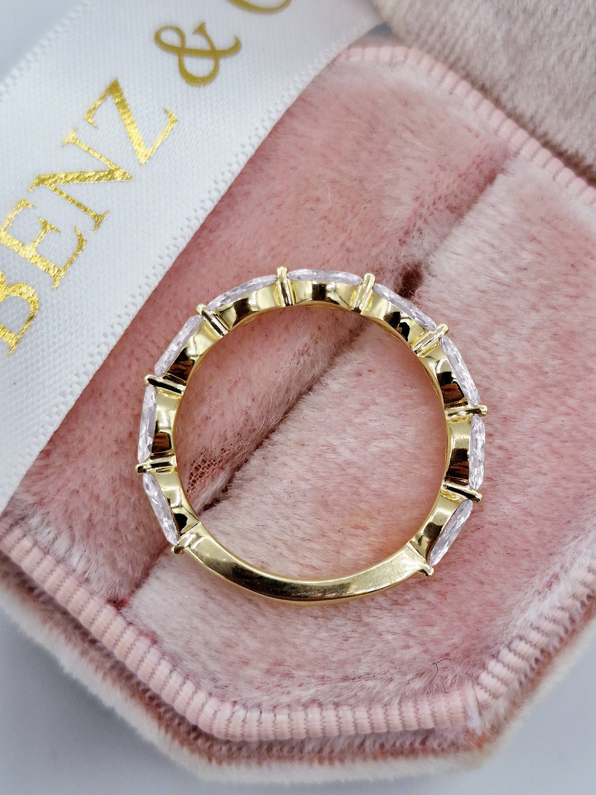 Marquise cut diamond eternity band in yellow gold