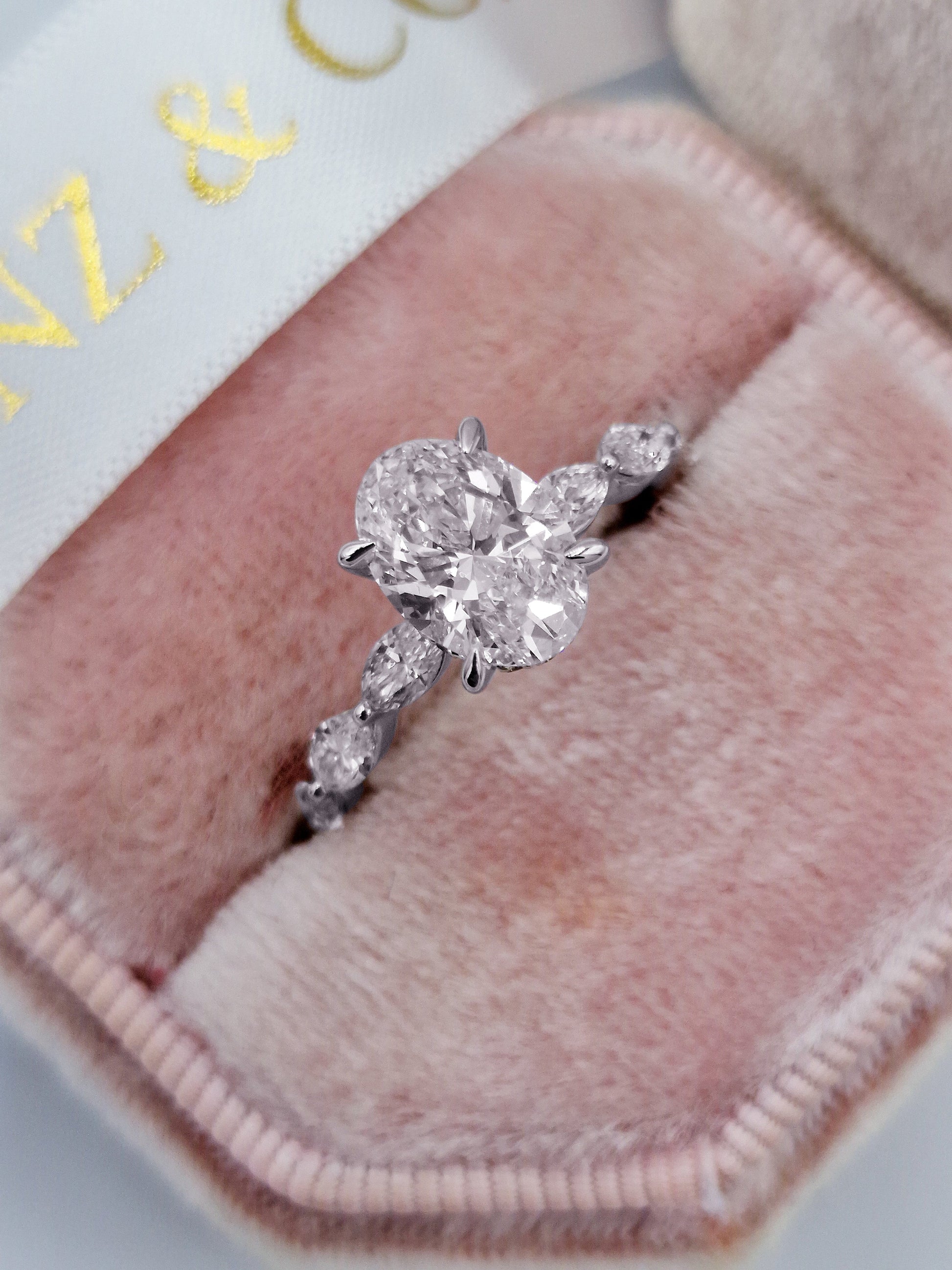 Oval diamond engagement ring with marquise side stones