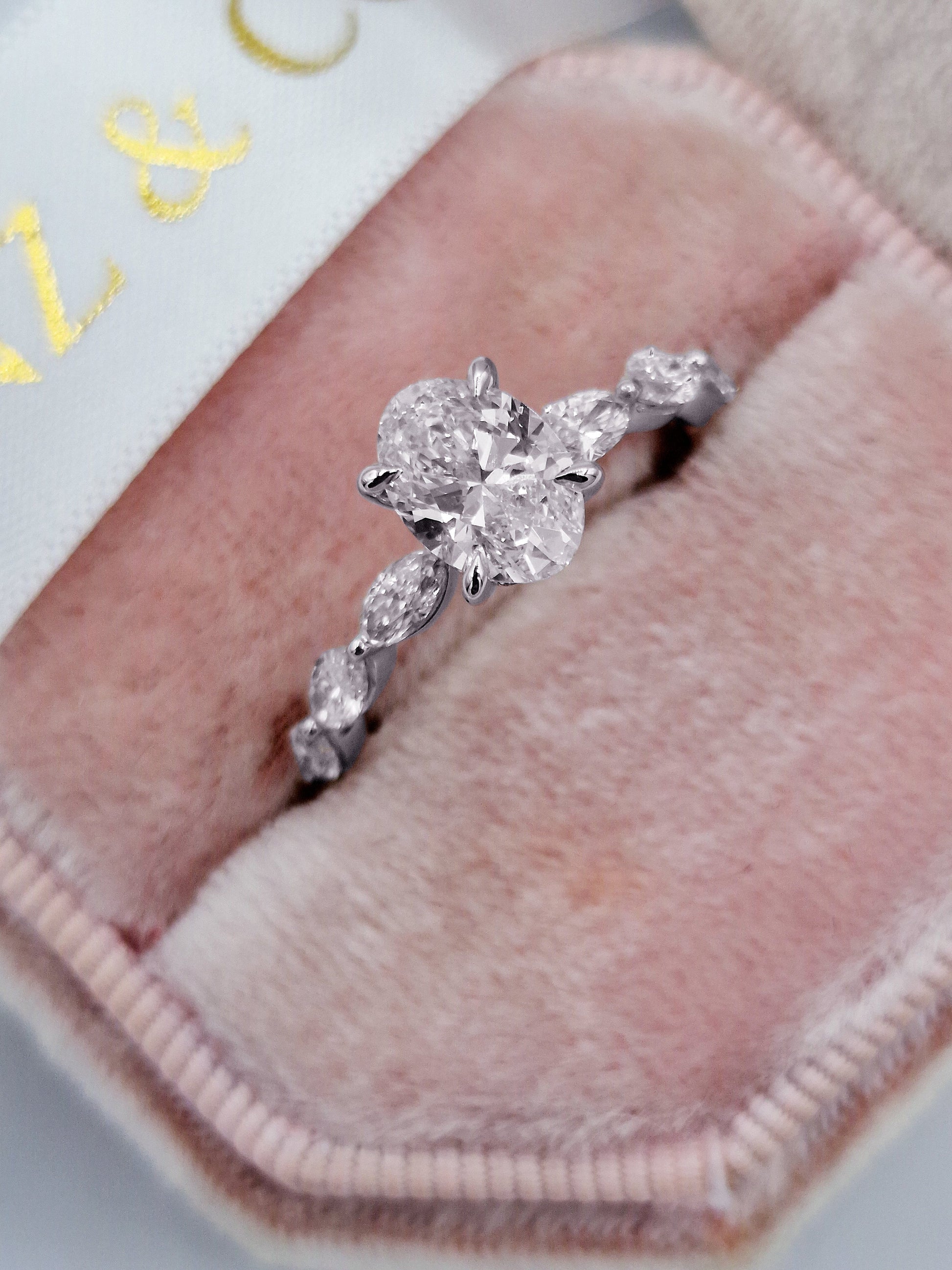 Oval diamond engagement ring with marquise side stones