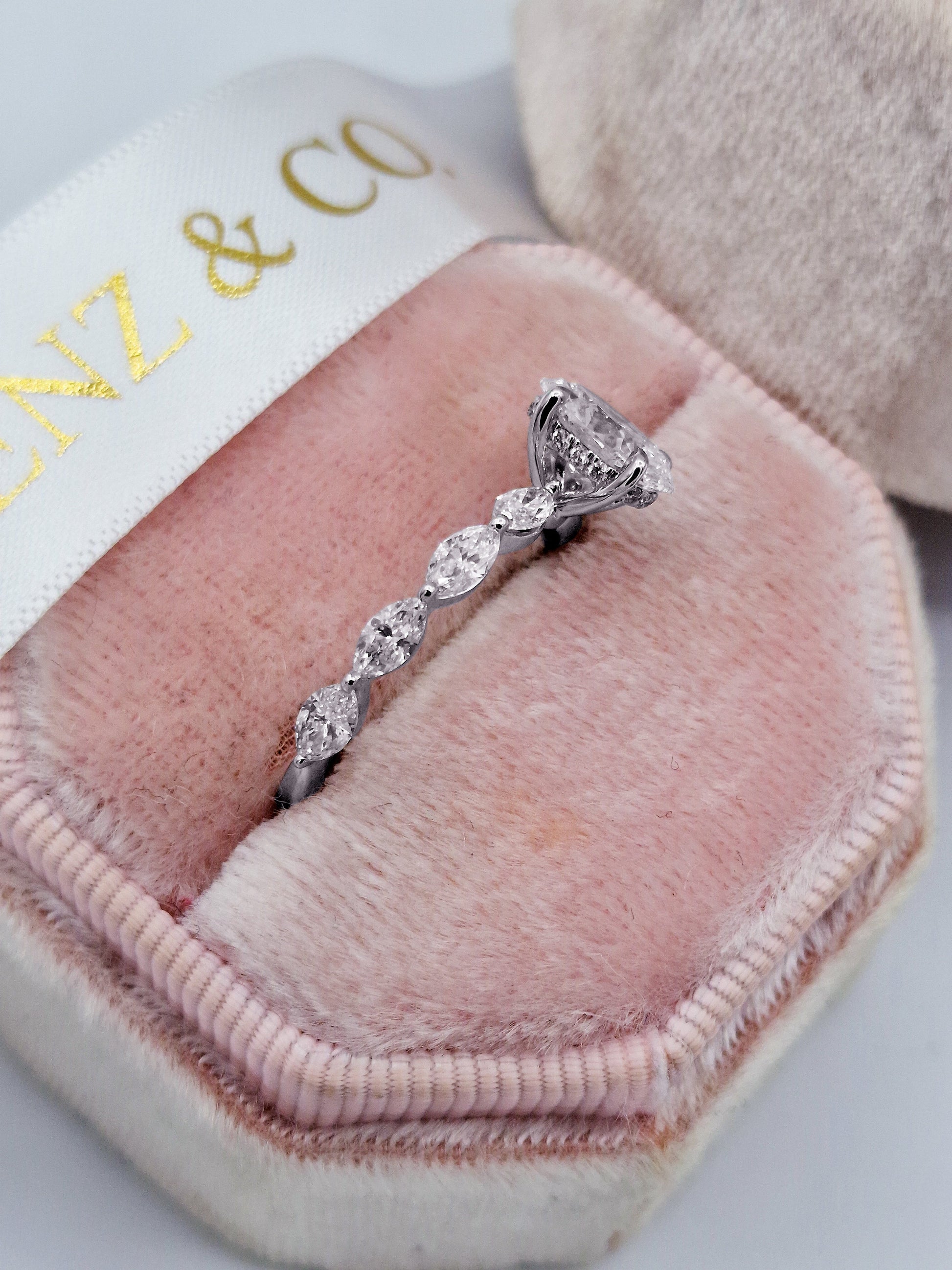 Oval diamond engagement ring with marquise side stones