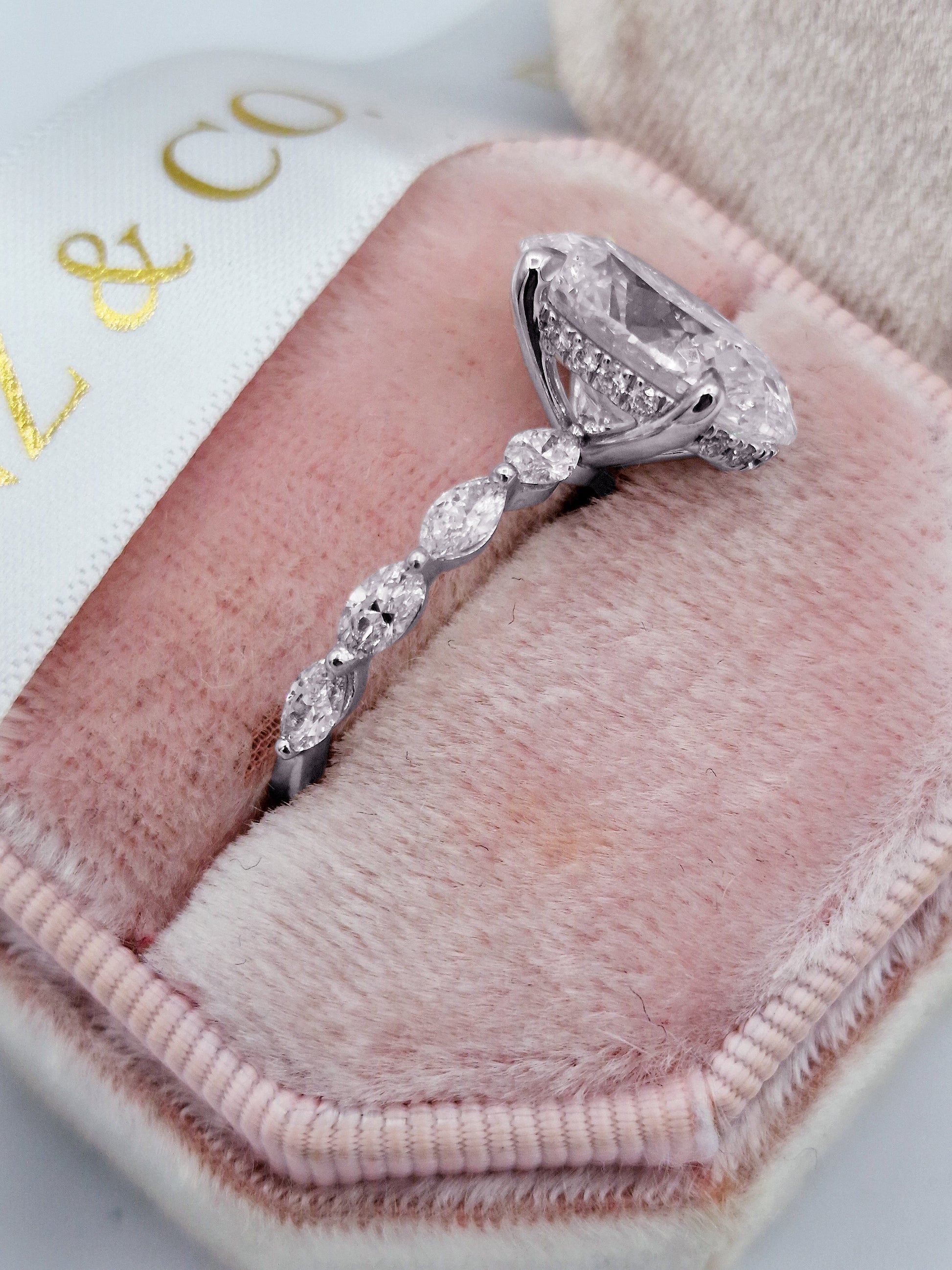 Oval 5ct diamond engagement ring with marquise side stones
