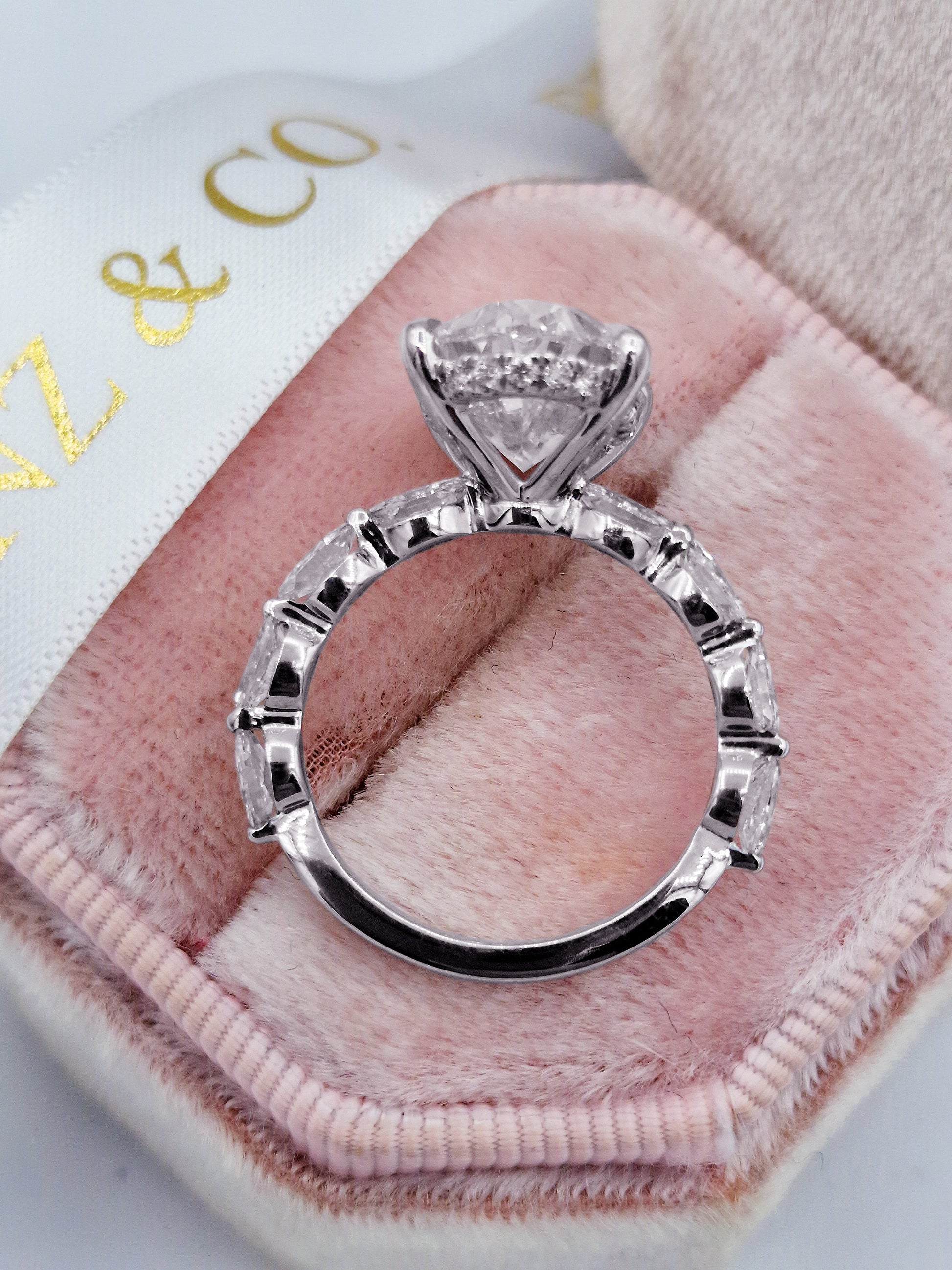 Oval diamond engagement ring with marquise side stones