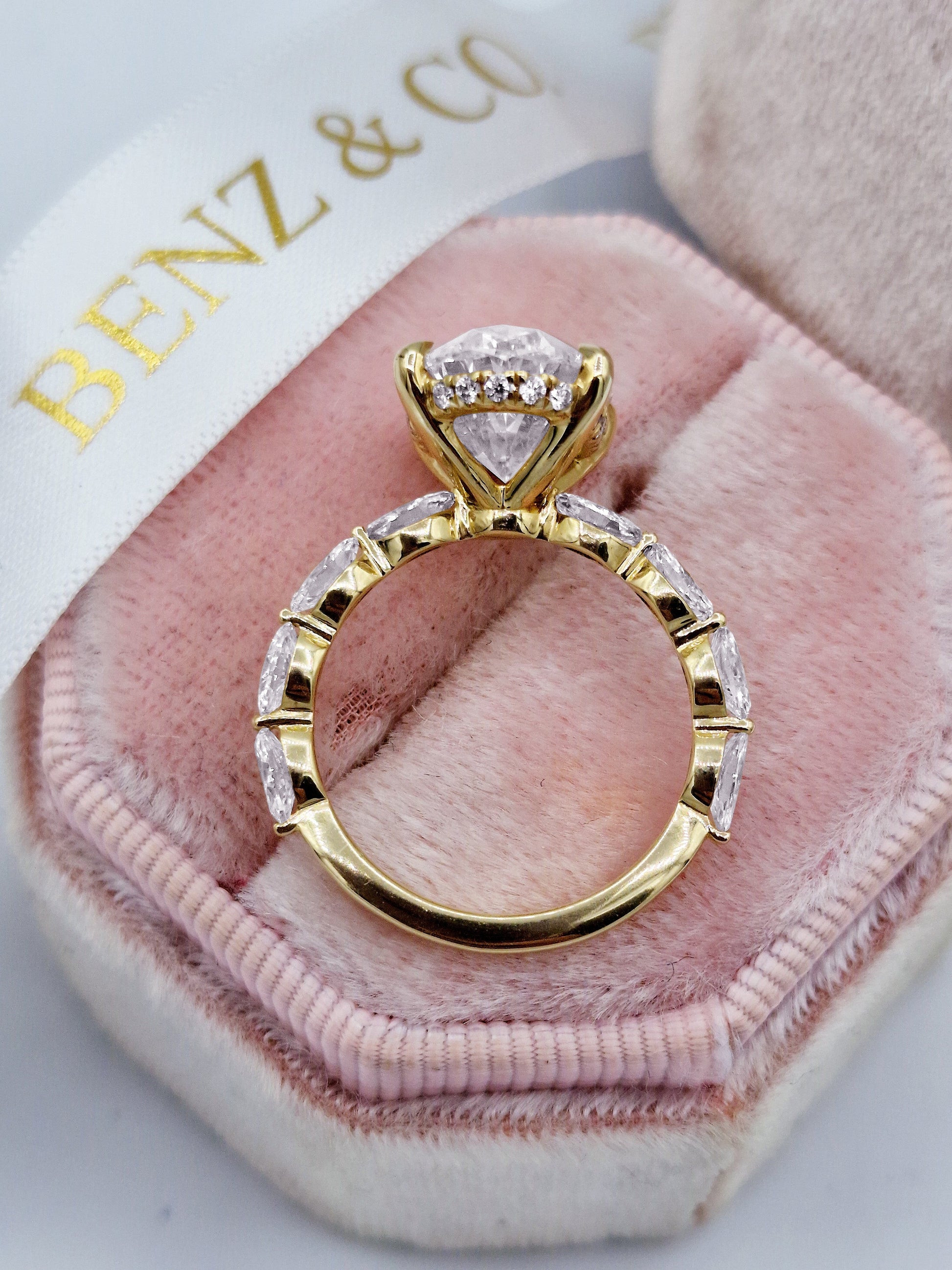 Oval 5ct diamond engagement ring with marquise diamonds, yellow gold