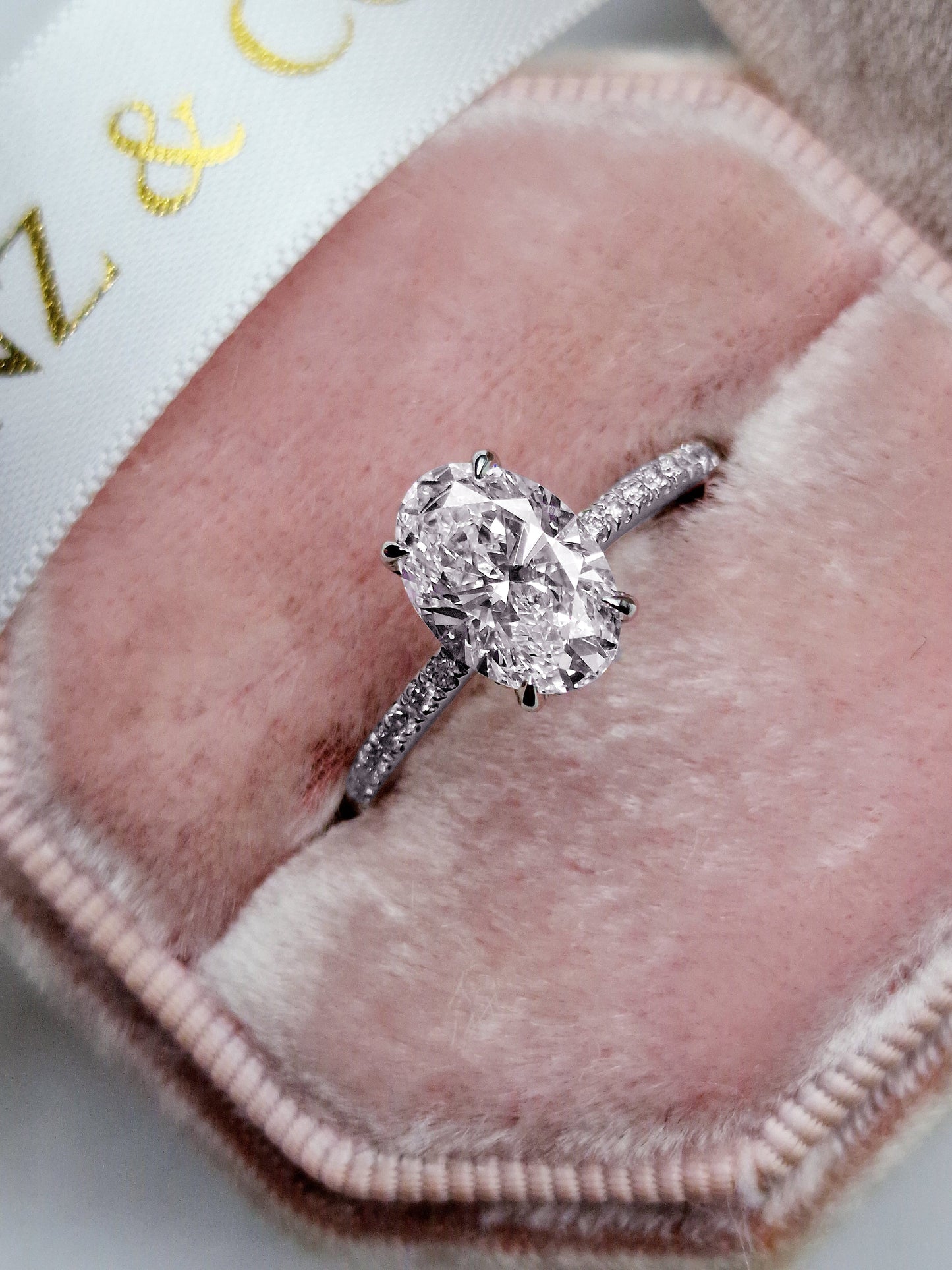 Oval cut 1.5ct lab grown diamond engagement ring with hidden halo