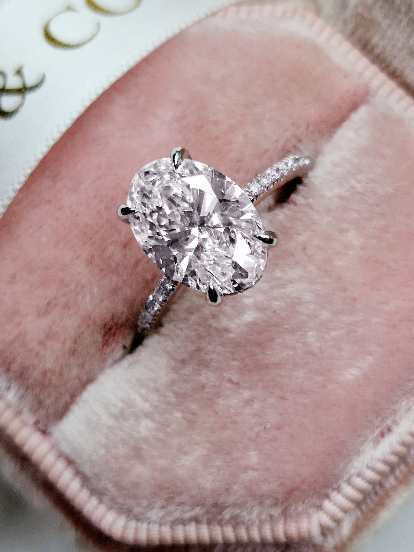 Oval cut 3ct lab grown diamond engagement ring with hidden halo