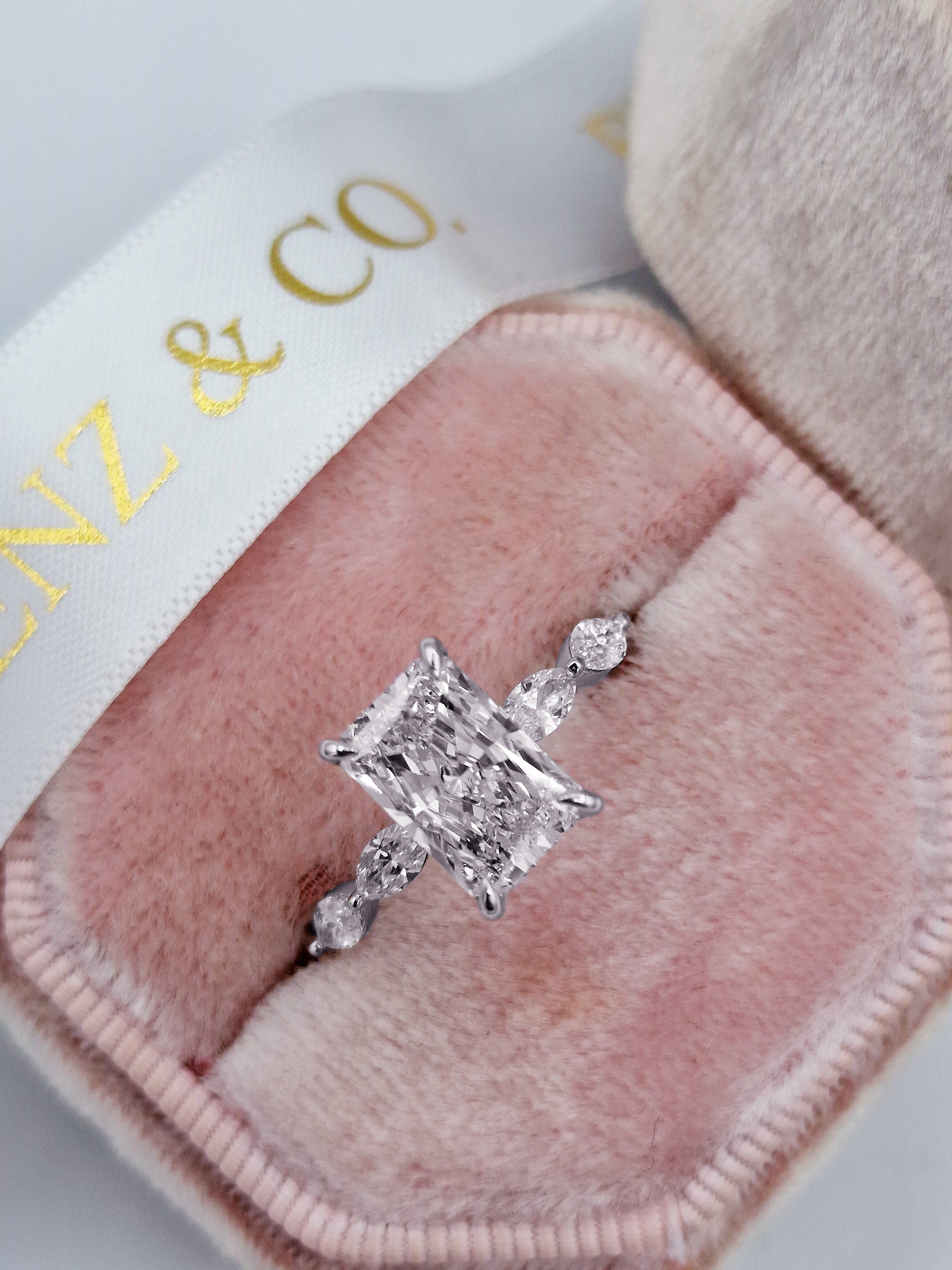 Radiant cut diamond engagement ring with marquise accents