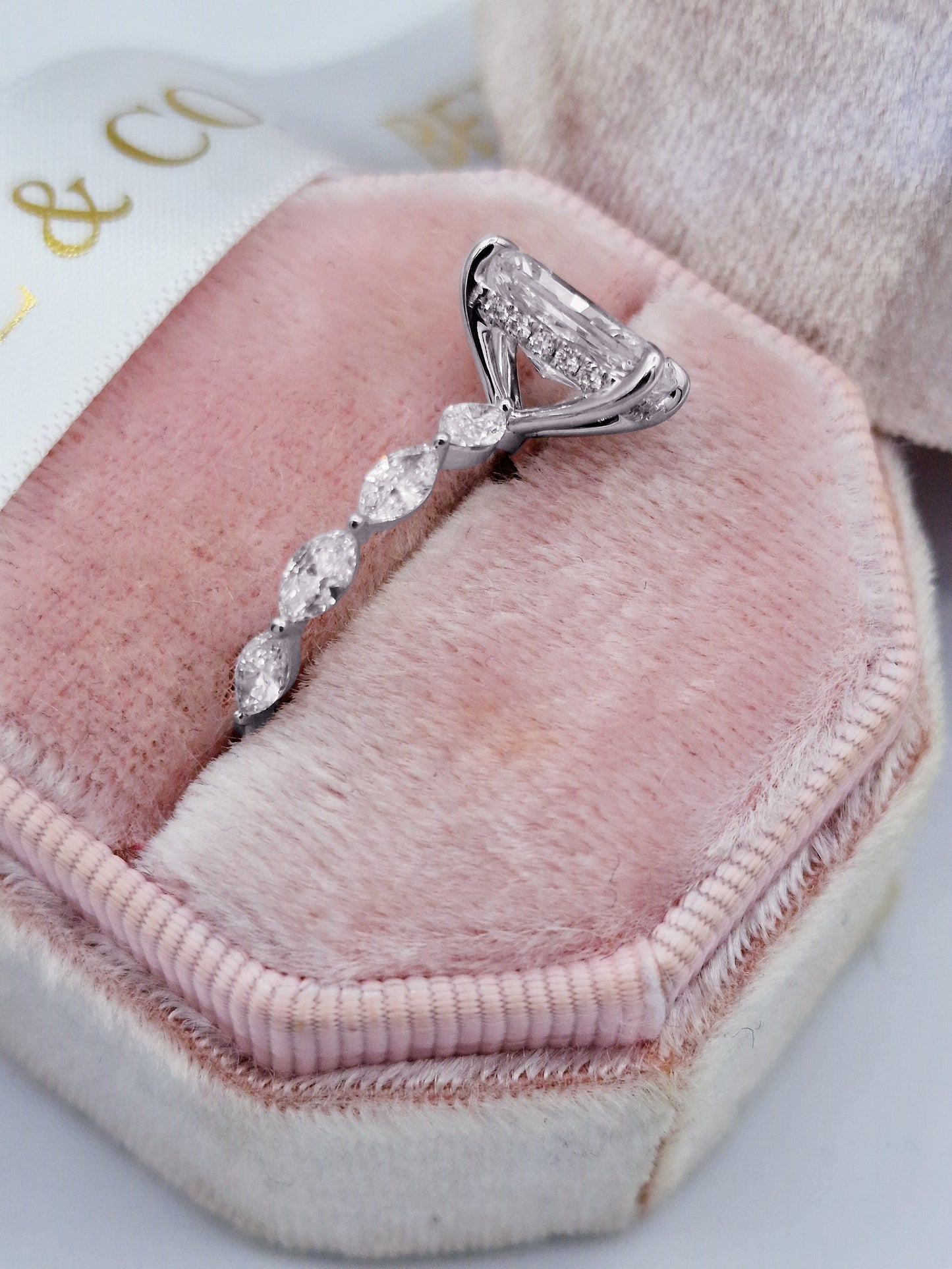 Radiant cut diamond engagement ring with marquise side stones