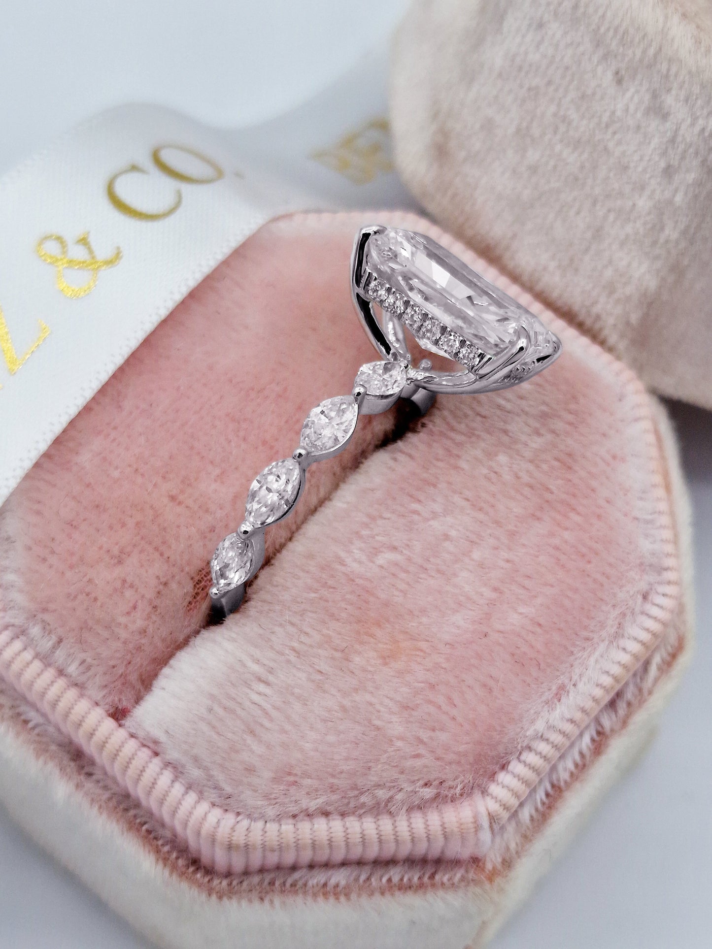 Radiant cut diamond engagement ring with marquise side stones