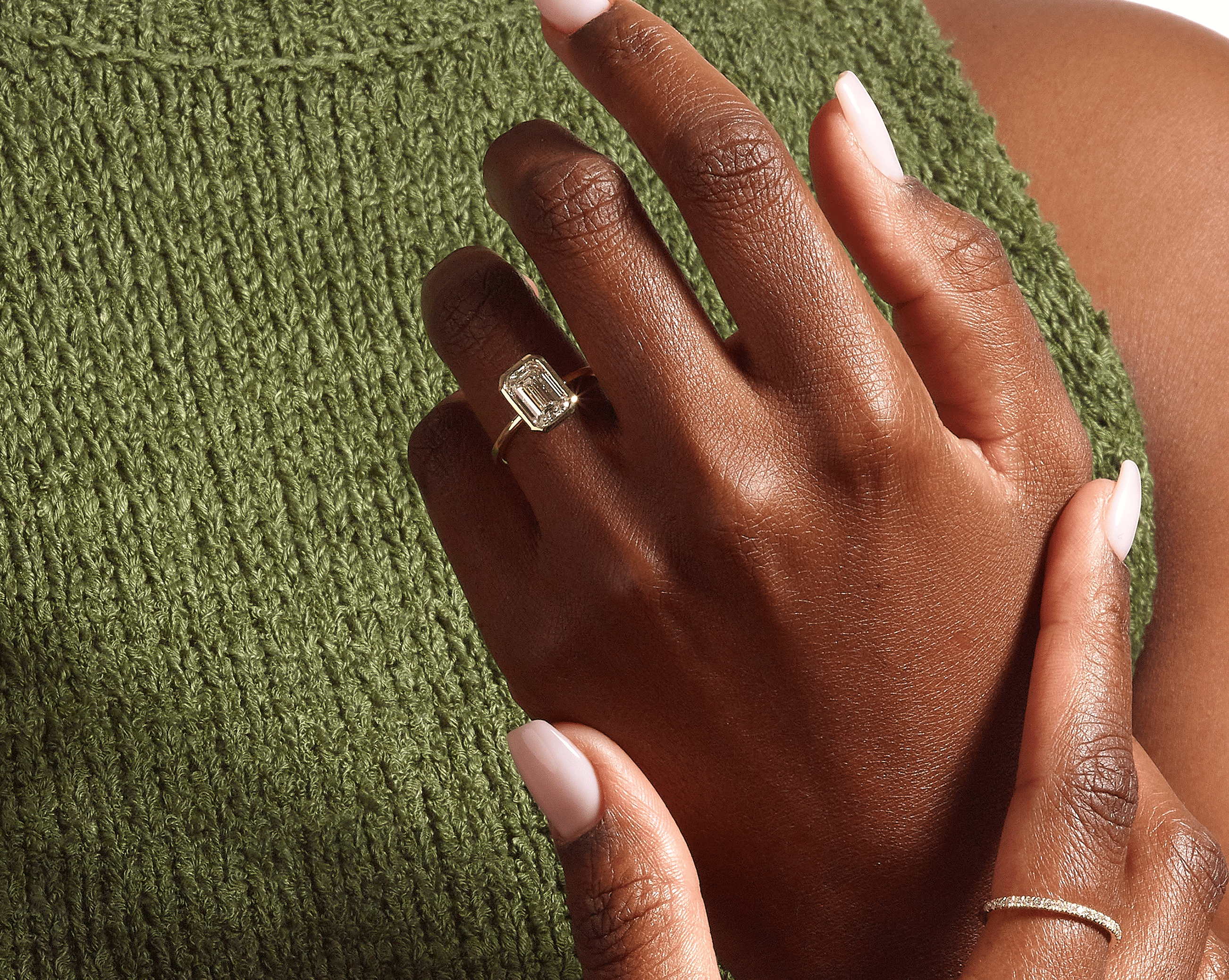 Emerald cut diamond ring on hand