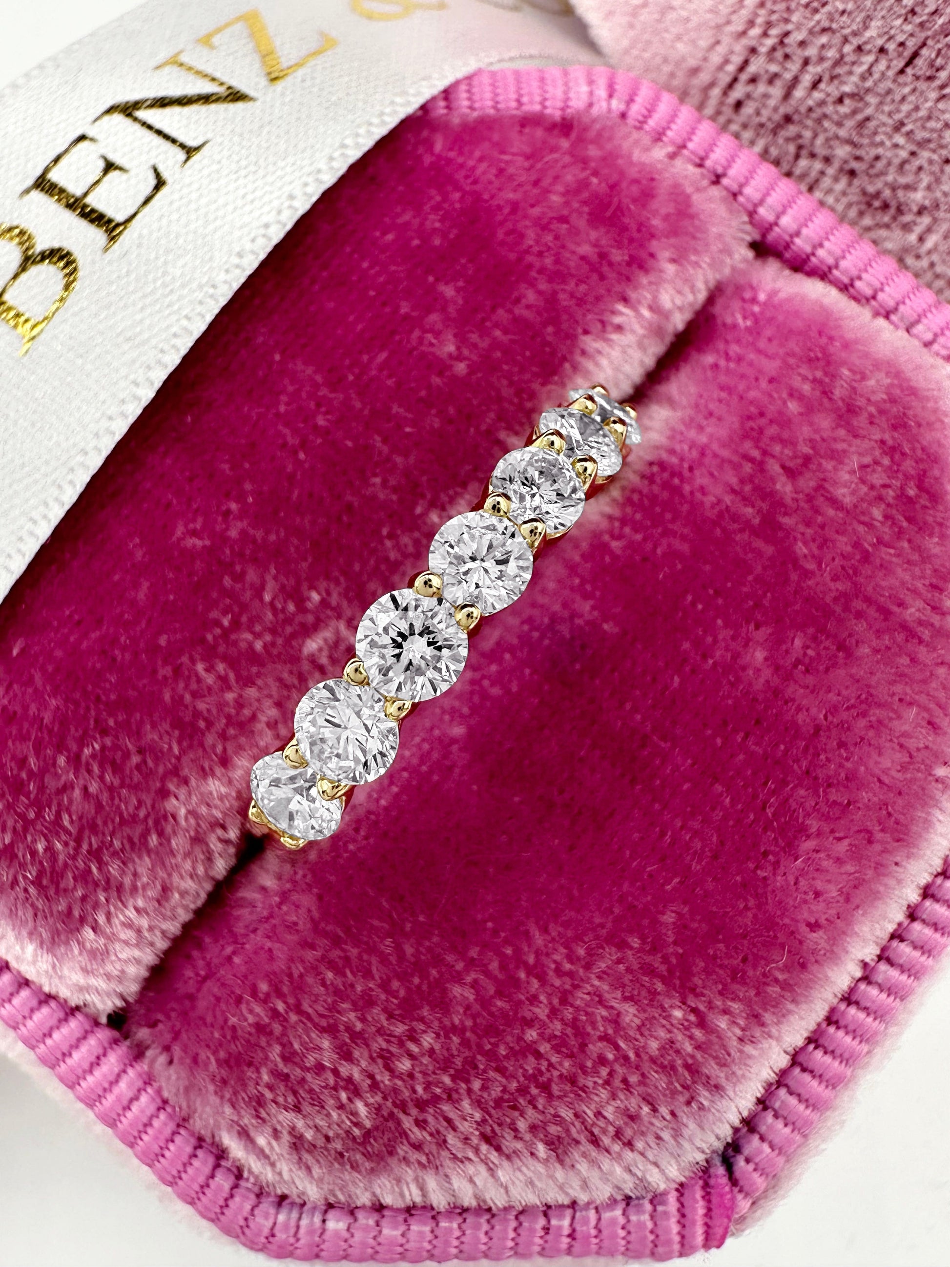 Round cut lab grown diamond eternity band in 14k yellow gold
