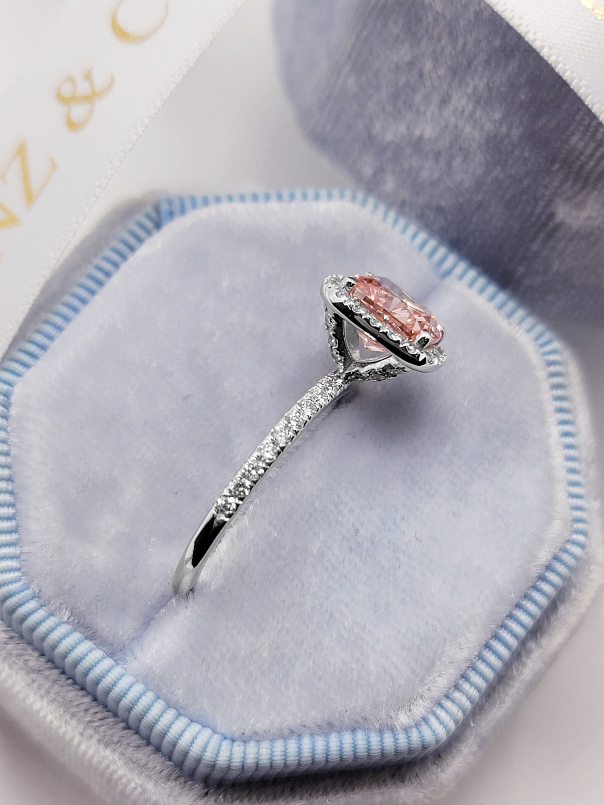Pink diamond ring in a velvet box.