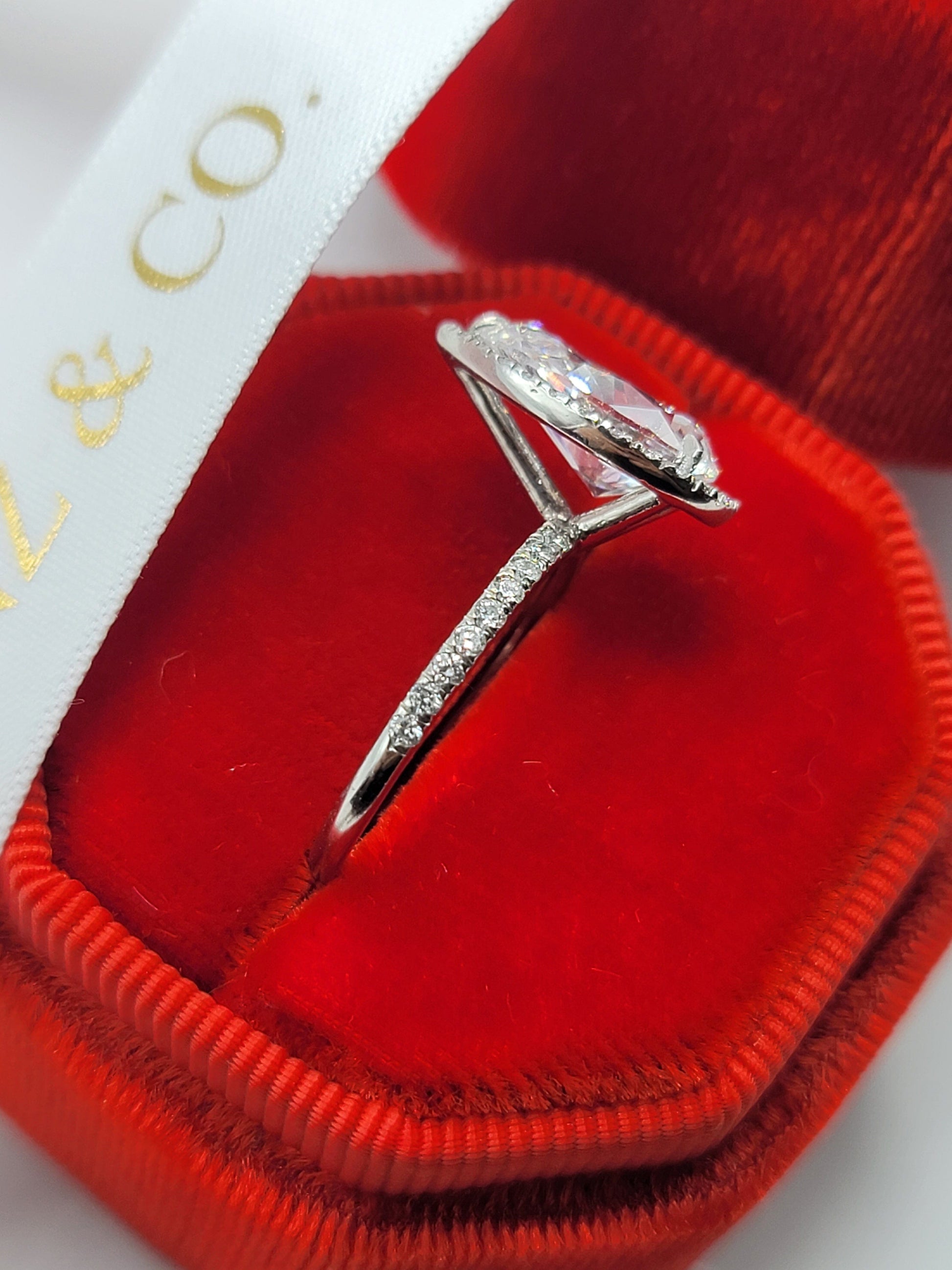 Diamond engagement ring in a red velvet box.