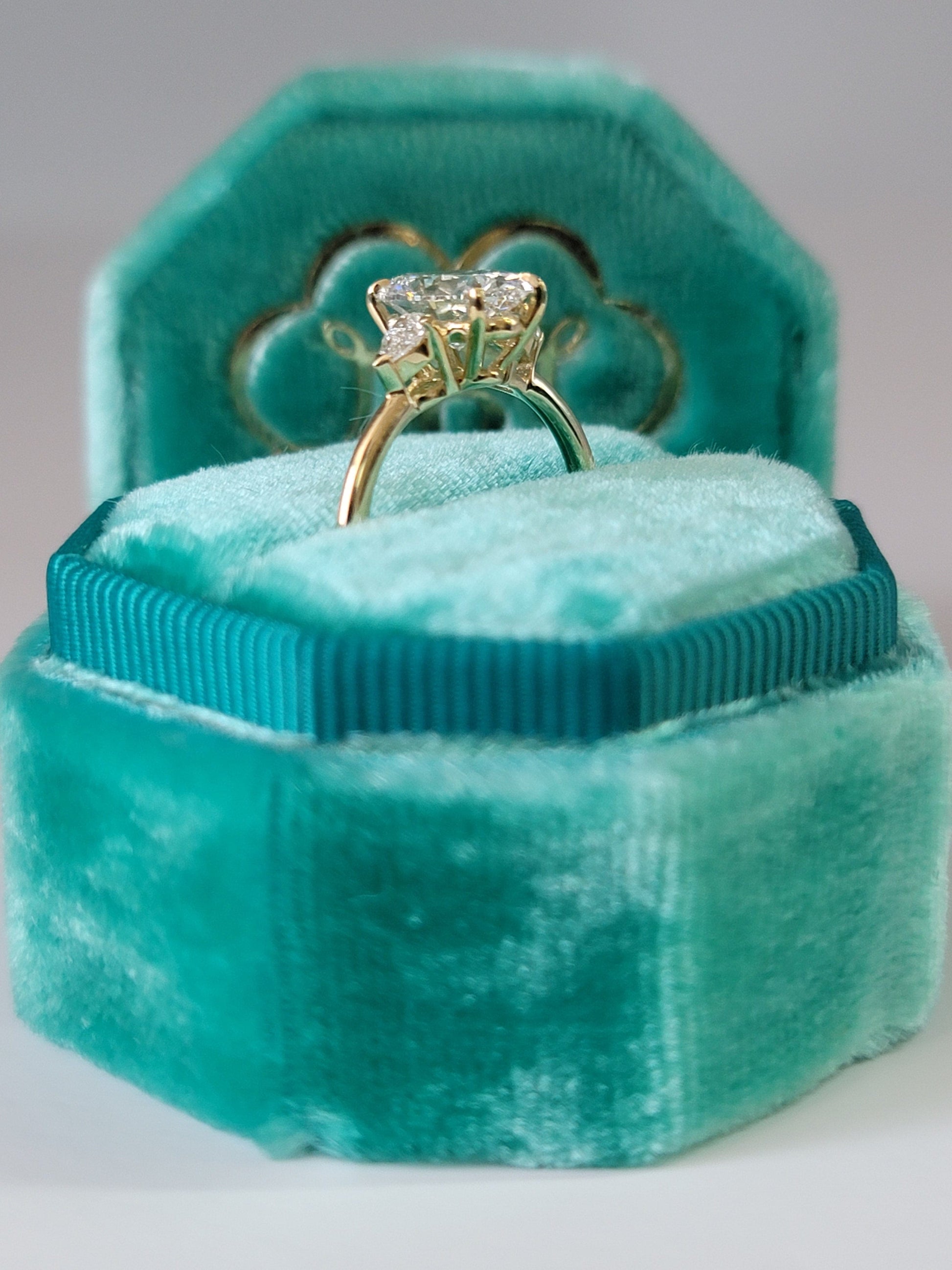 Diamond ring in a turquoise velvet box.