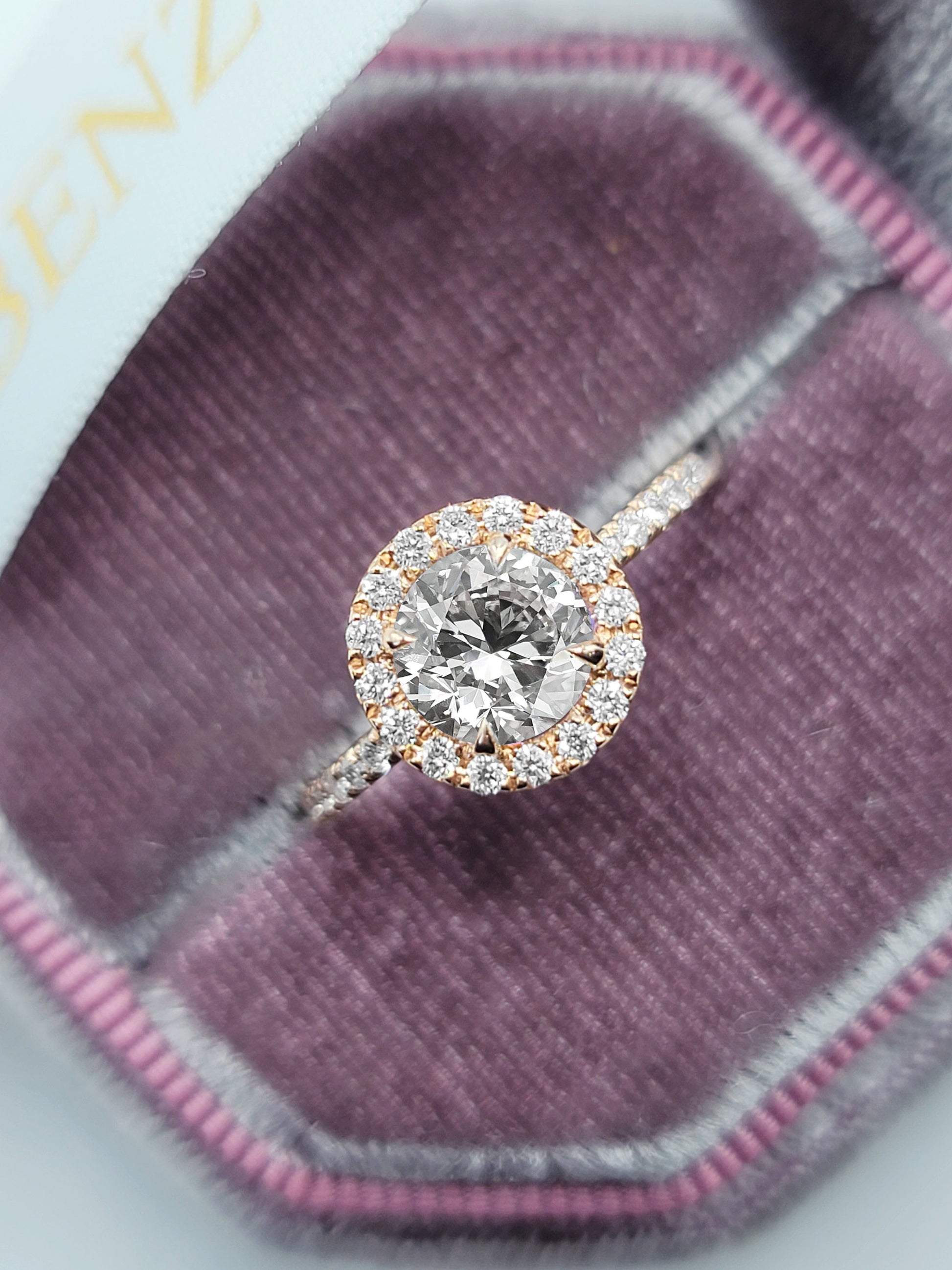 Diamond halo engagement ring in velvet box.