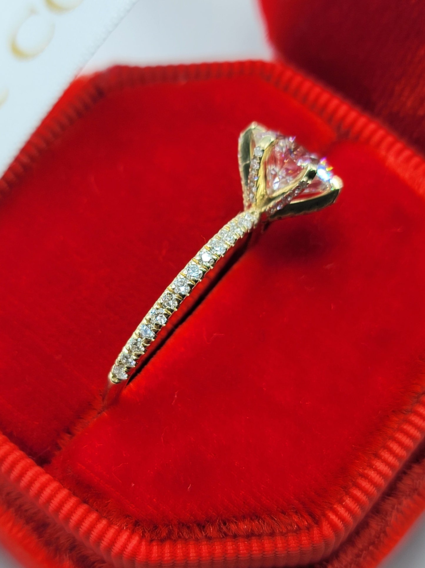 Gold diamond ring in a red box.