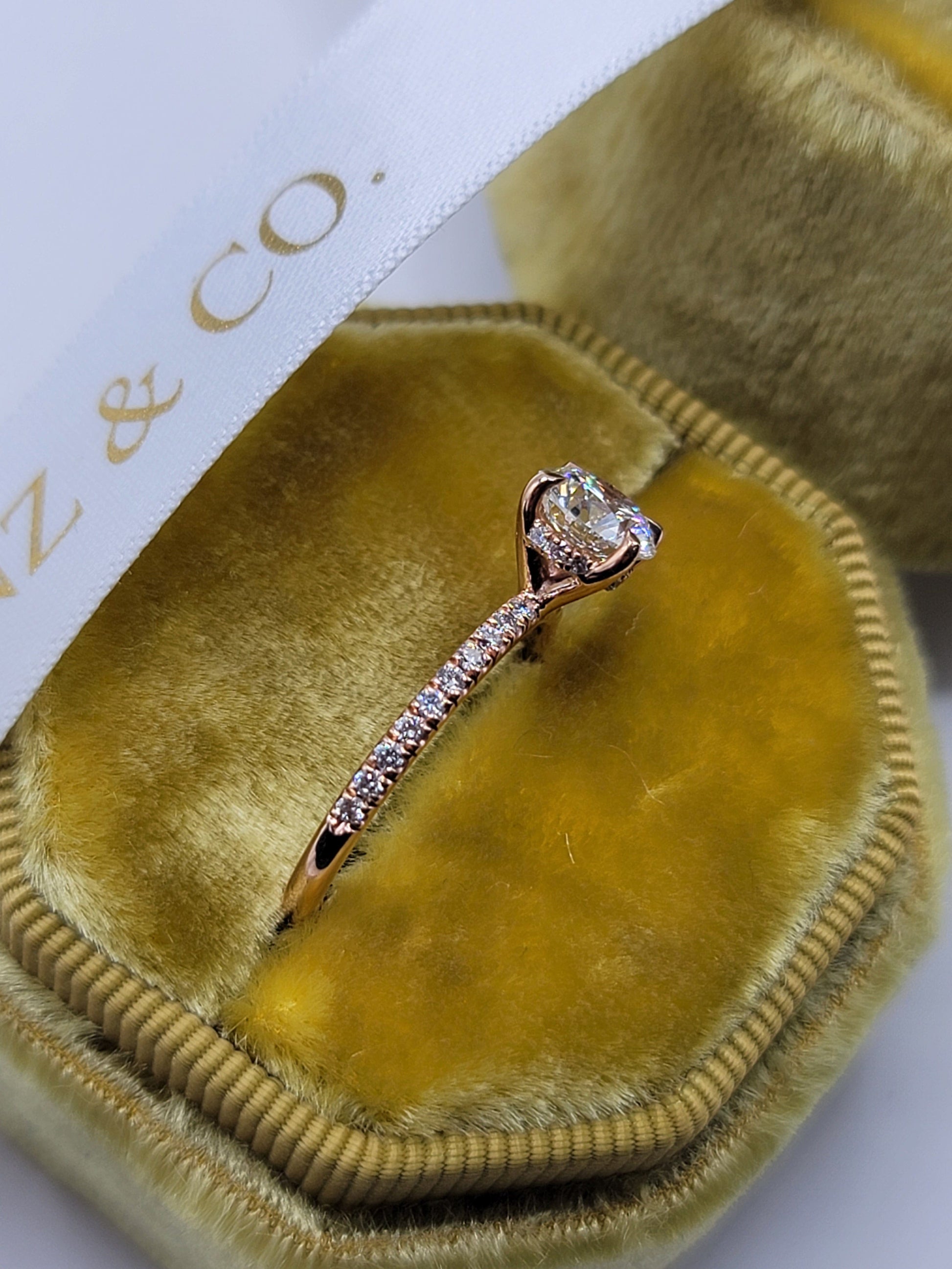 Diamond ring in a yellow velvet box.