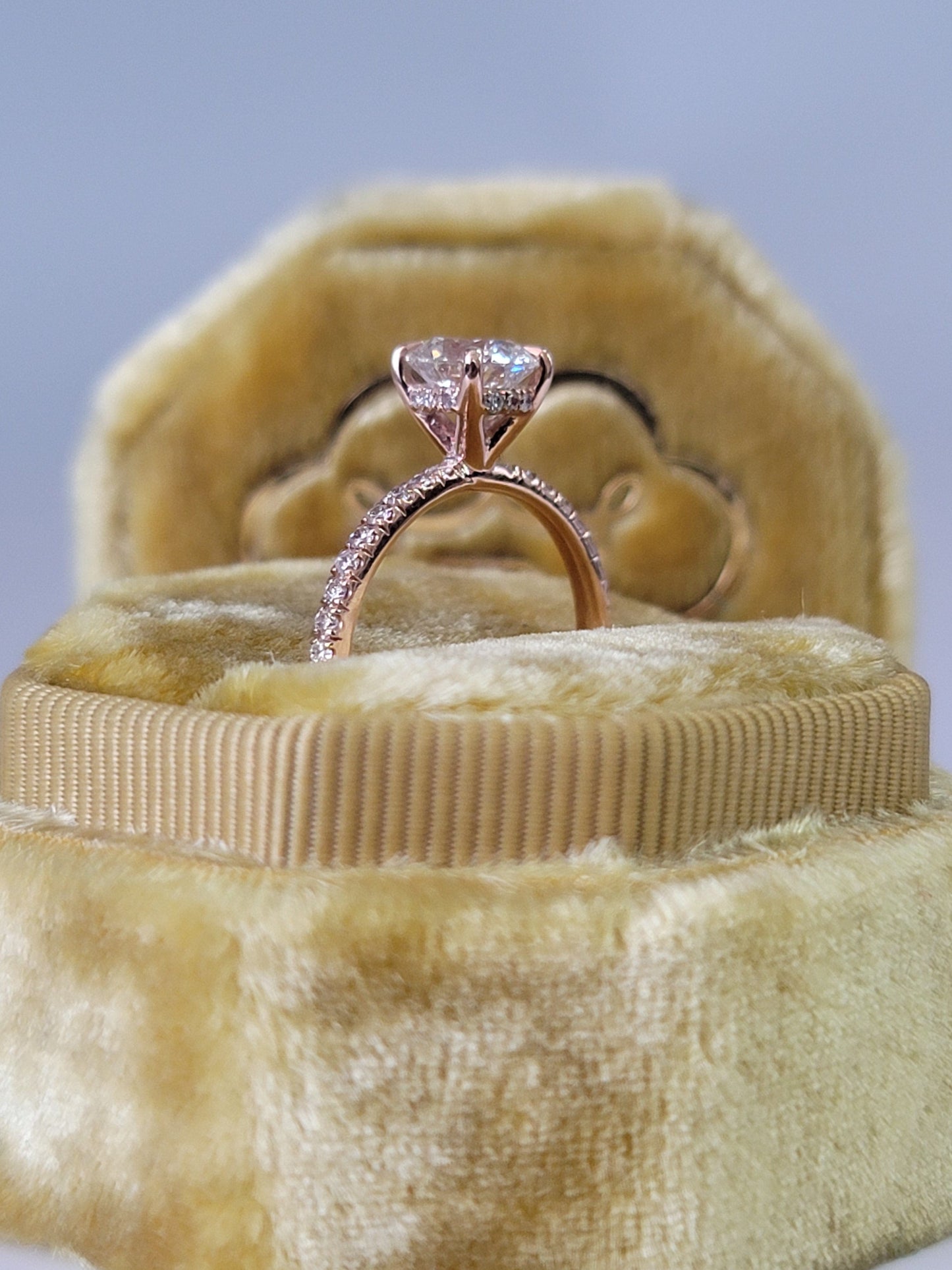 Rose gold engagement ring in velvet box.