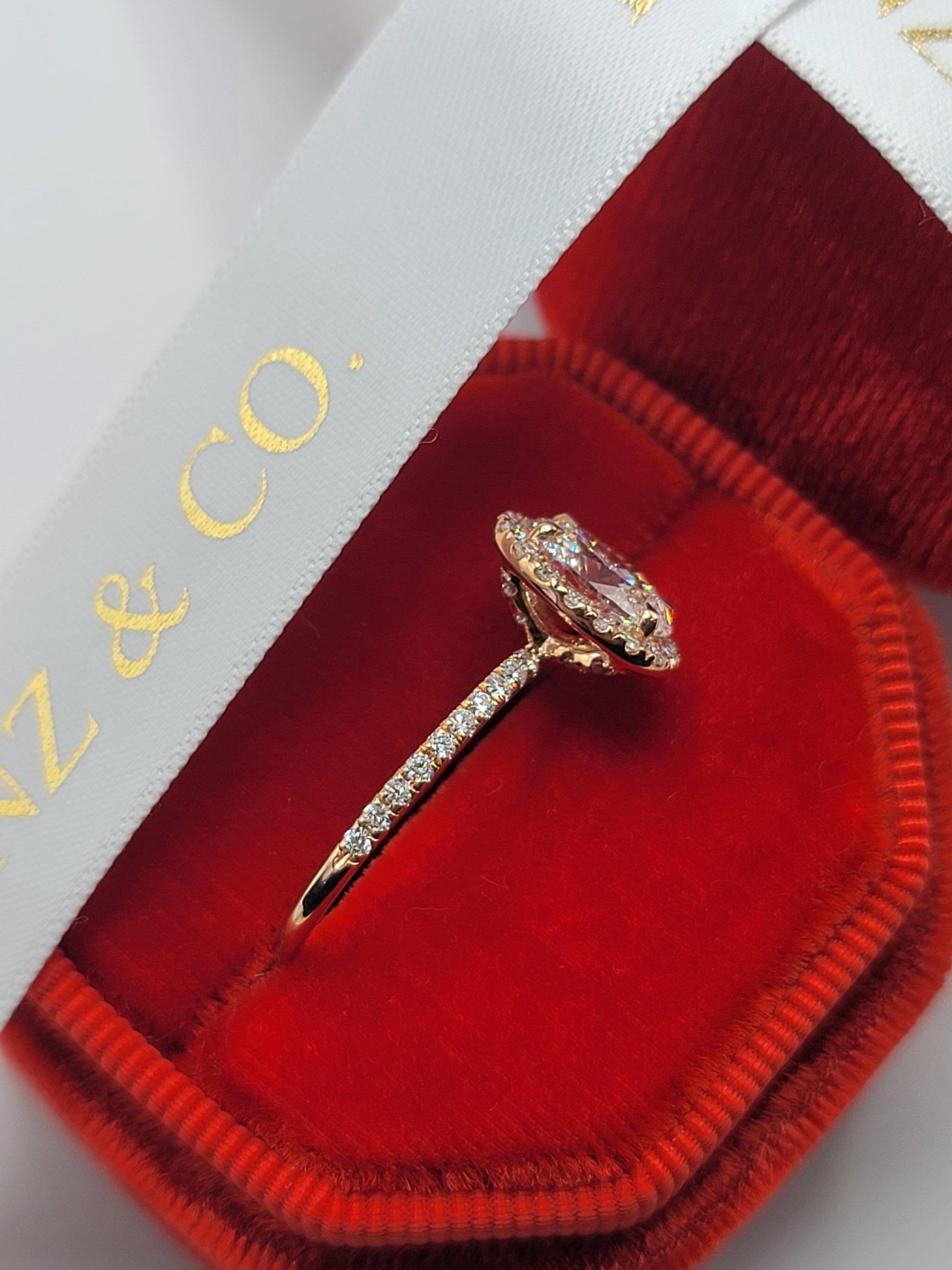 Diamond engagement ring in a red velvet box.