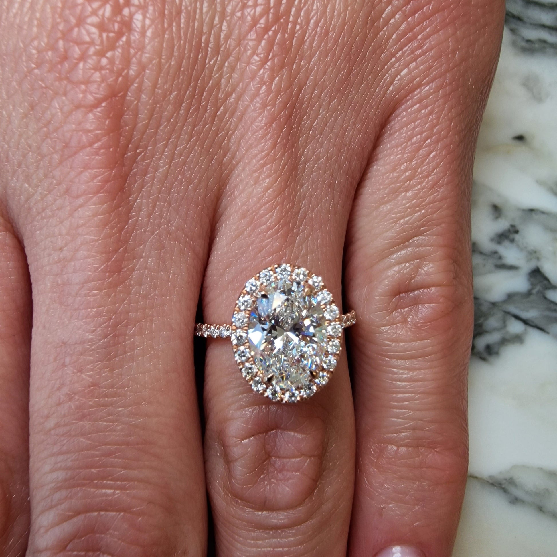Diamond engagement ring on a hand.