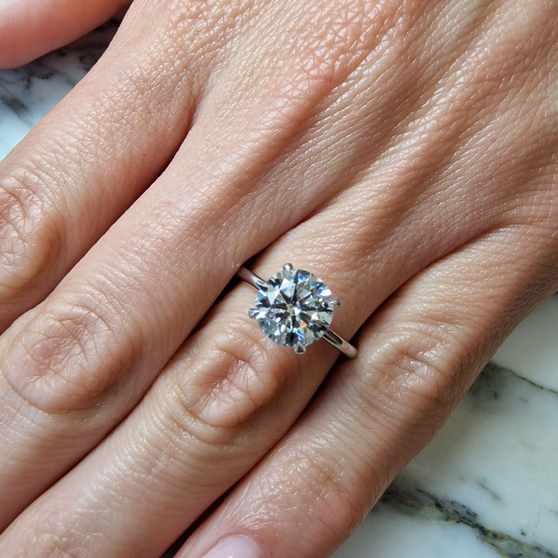 Hand with diamond ring.