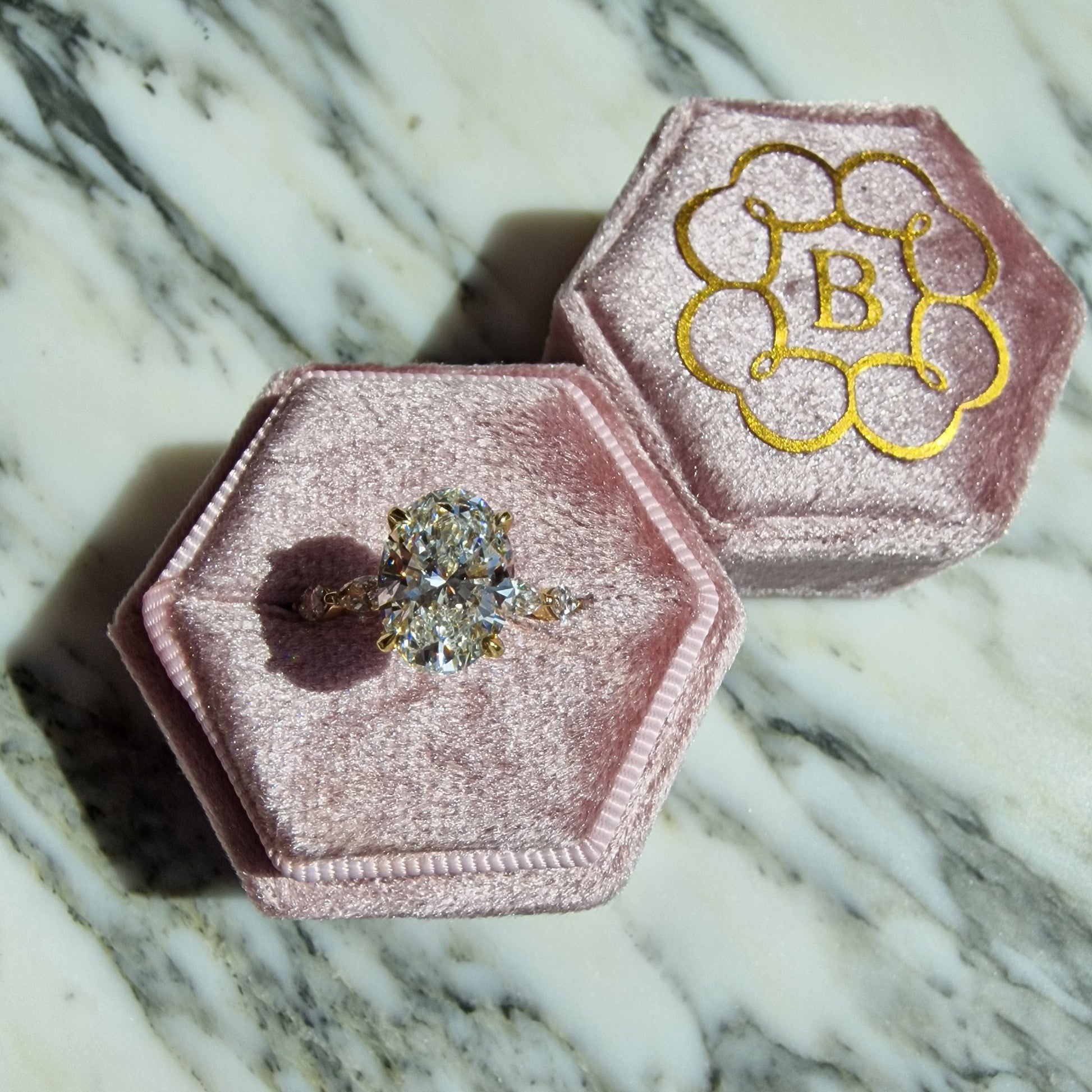 Diamond ring in pink velvet box.