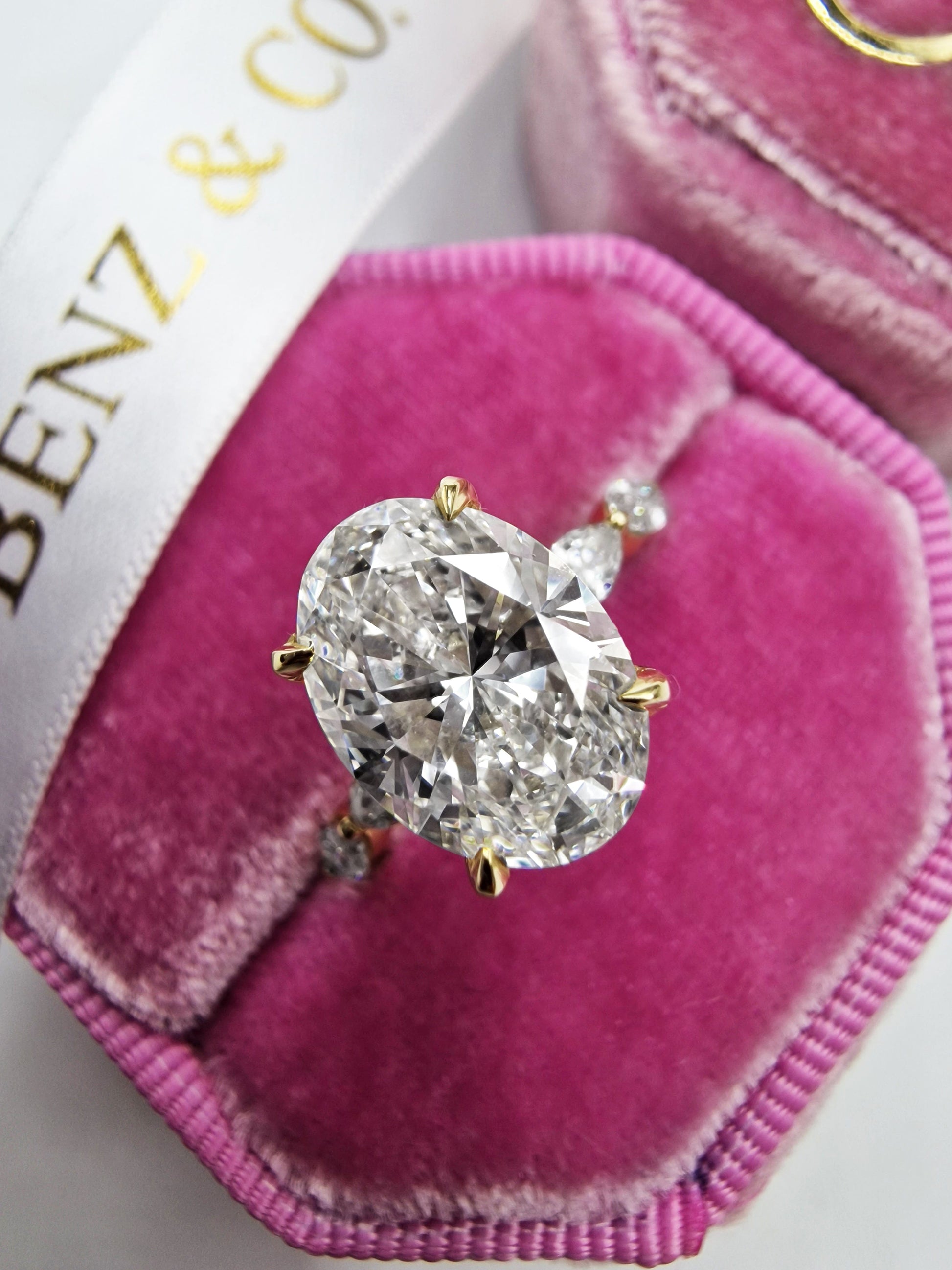 Diamond engagement ring in a pink velvet box.